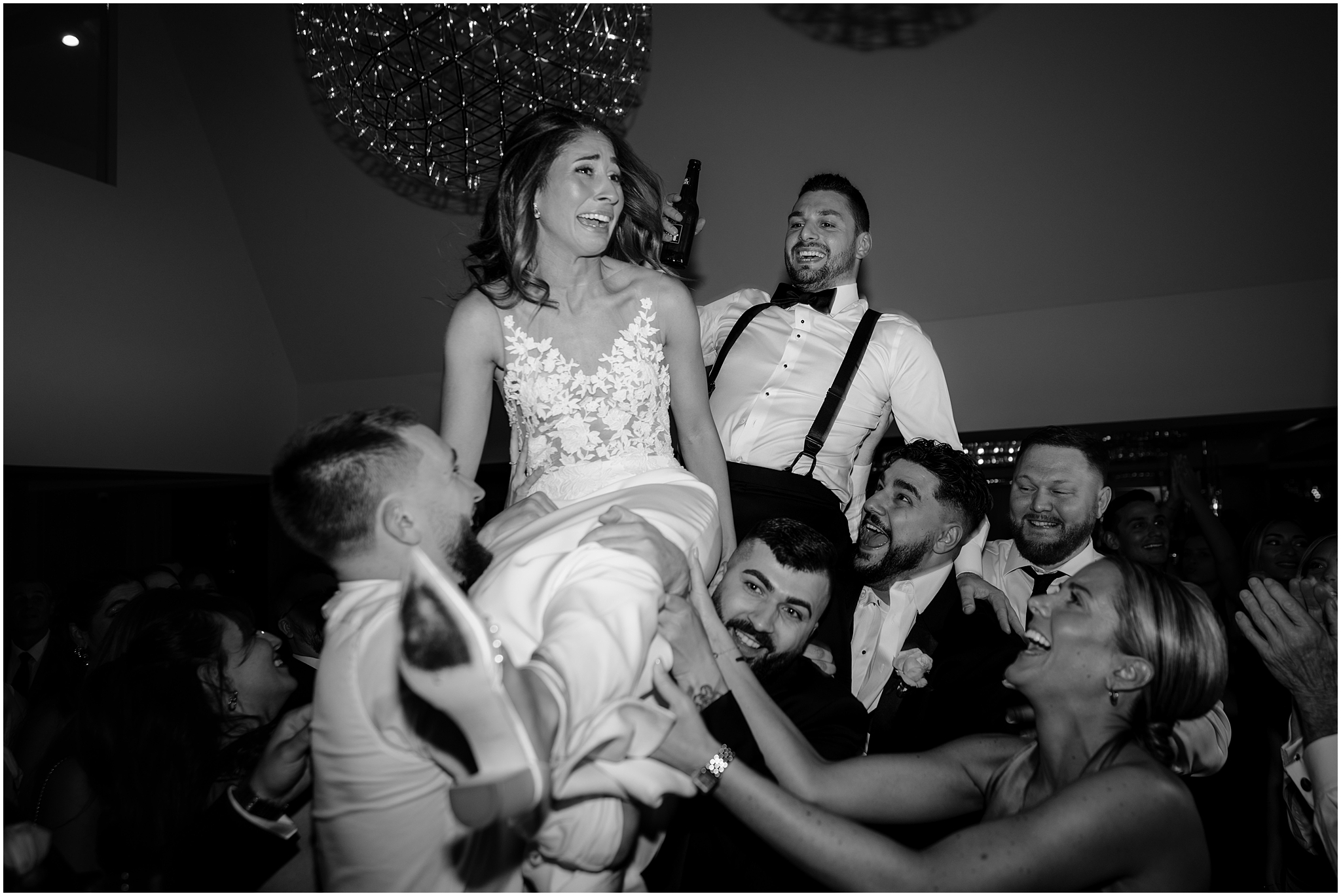 bride and groom lifted in the air during Long Island wedding reception