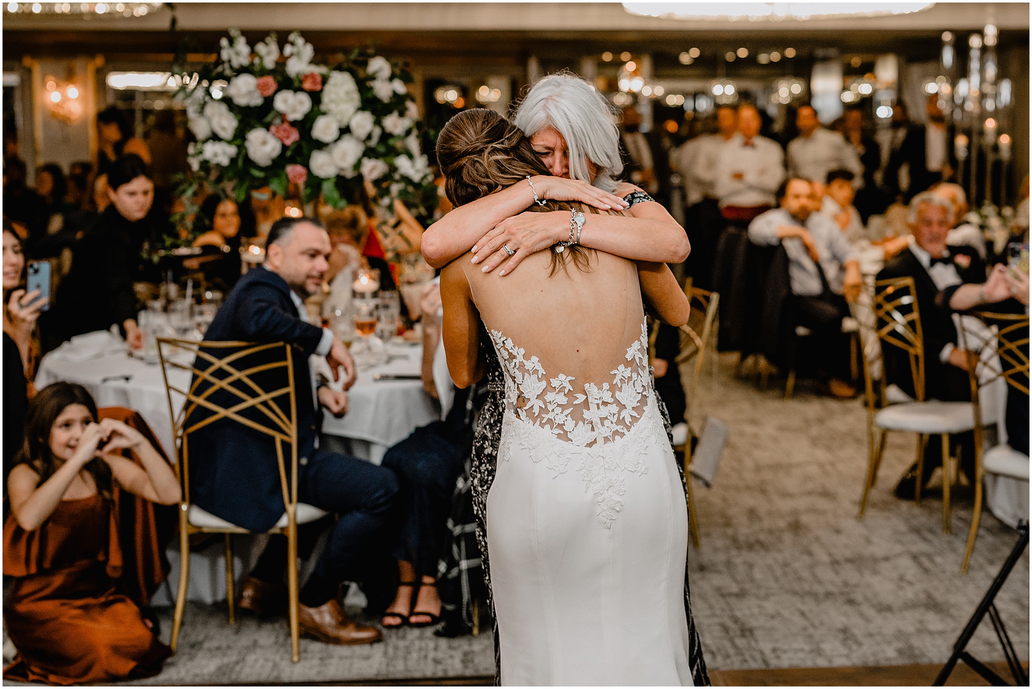 bride hugs mom on dance floor during Long Island wedding reception