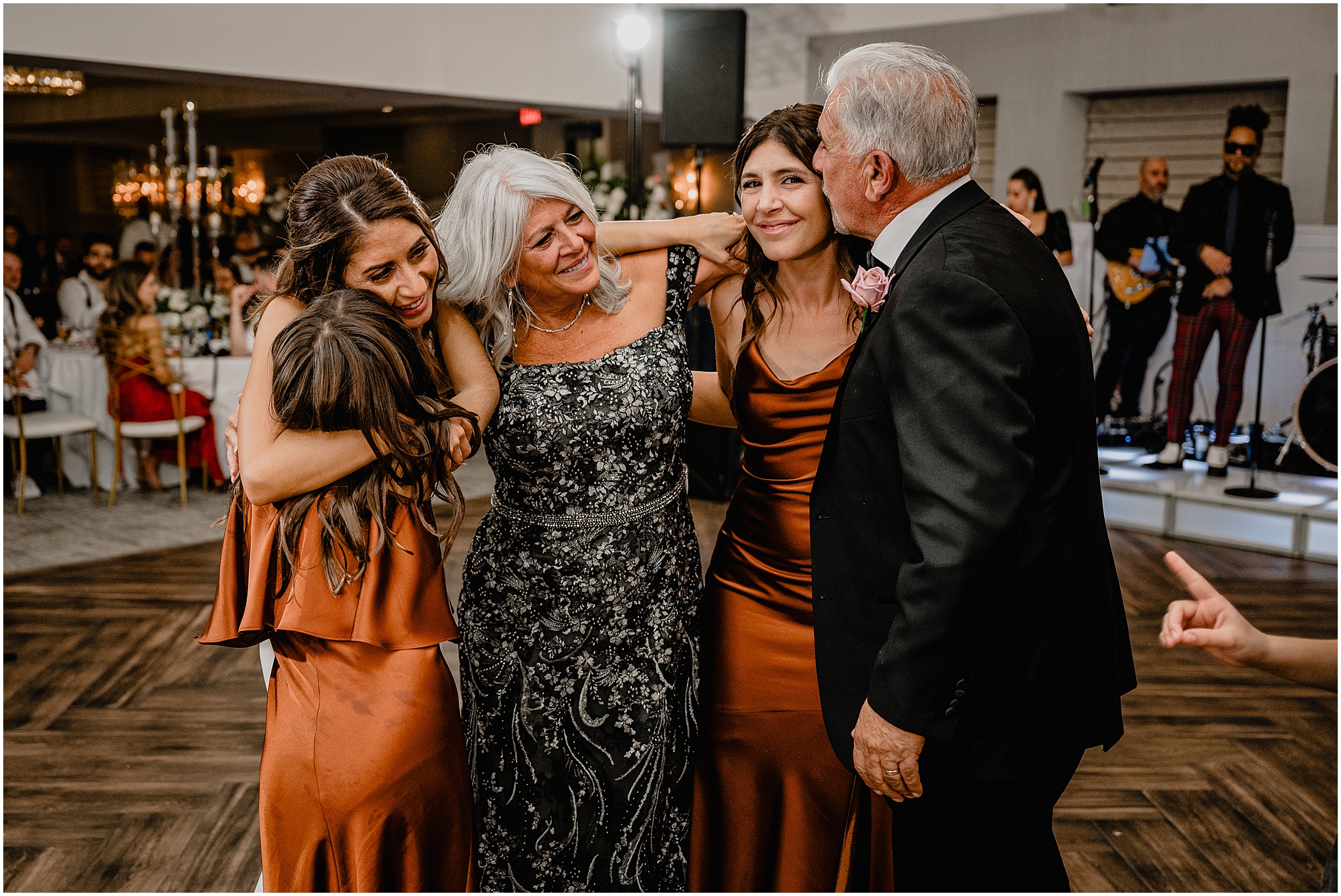 parents hug daughters and grandchildren on dance floor during Long Island wedding reception