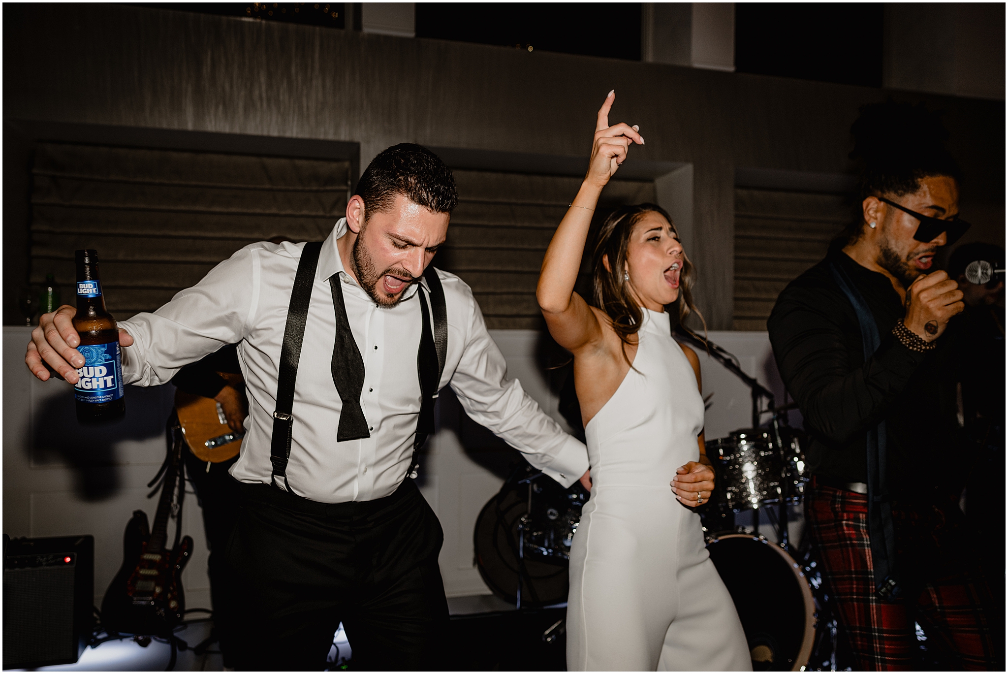 bride and groom sing with live band during Long Island wedding reception
