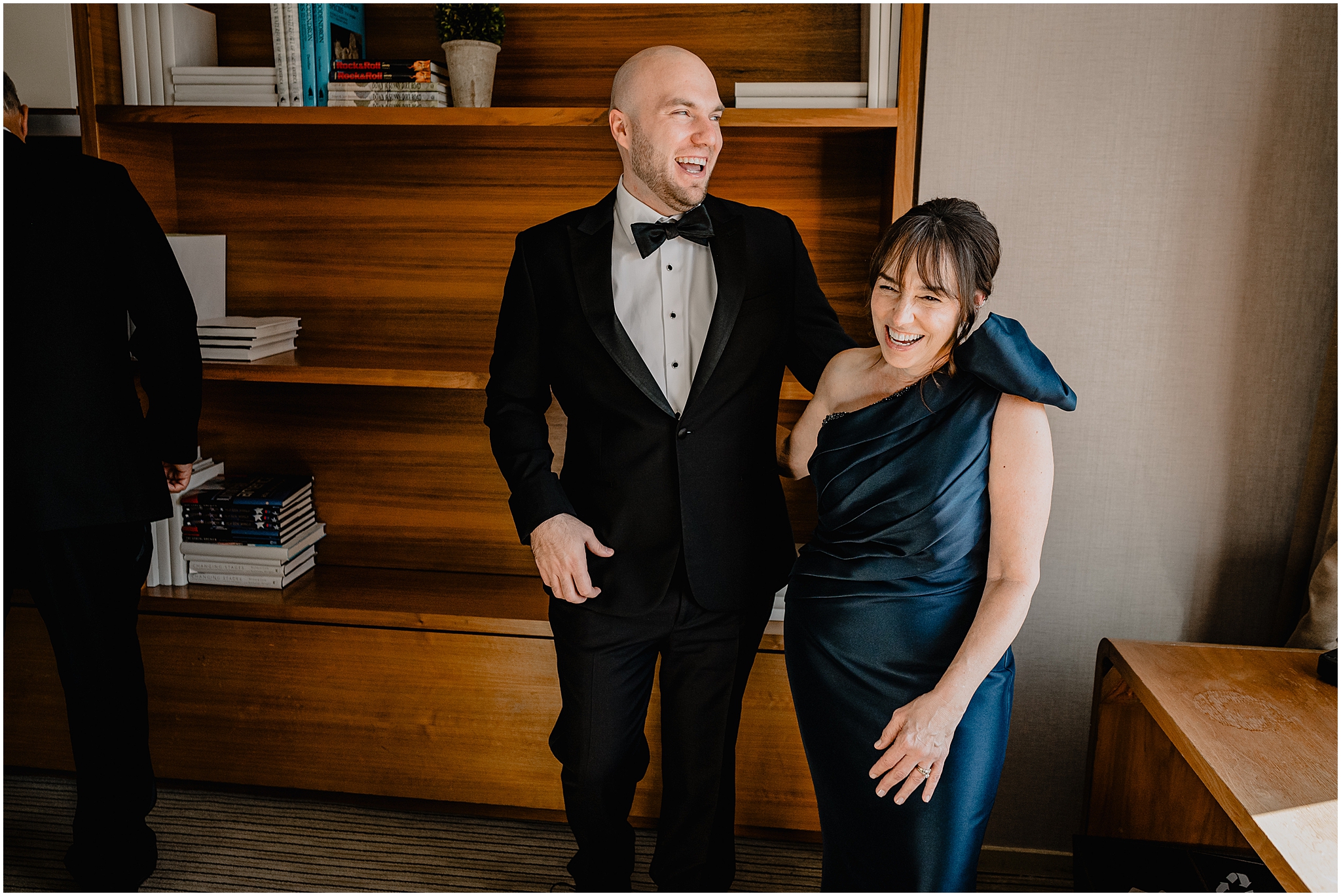 groom laughs with mom during prep for wedding at Liberty House Restaurant