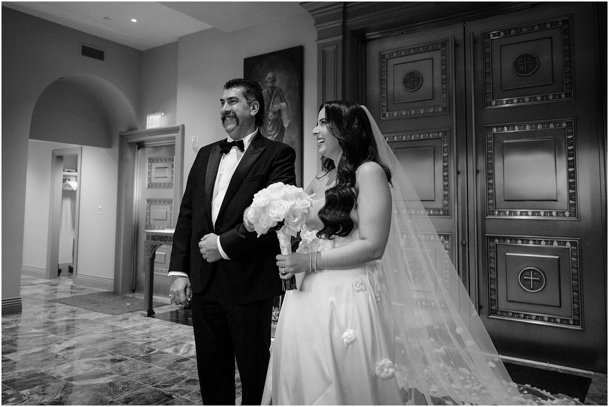 bride holds father's arm laughing standing inside church in New Jersey