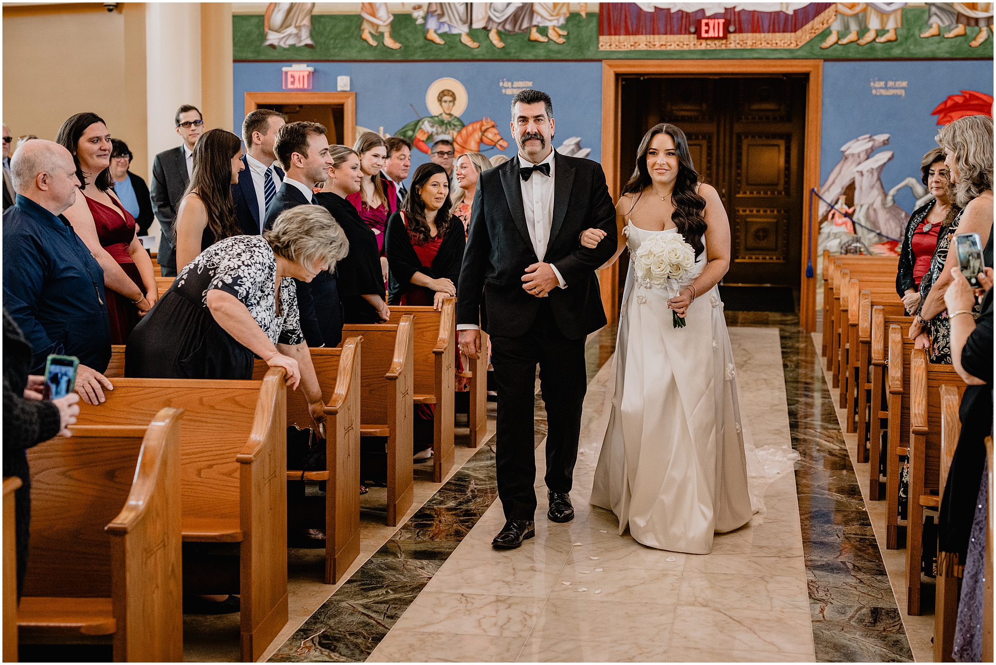 father walks bride down the aisle inside church for traditional wedding ceremony in New Jersey