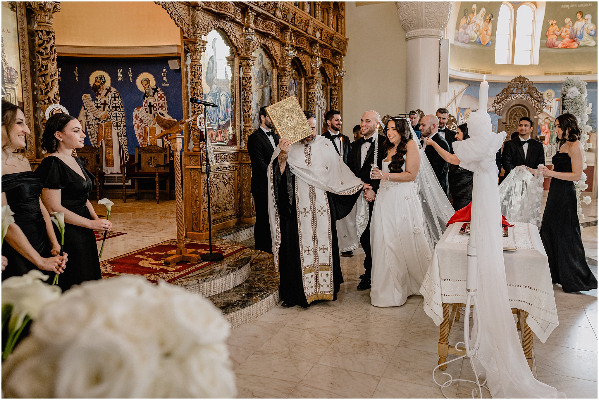 bride and groom walk around the table during traditional Orthodox church wedding in New Jersey