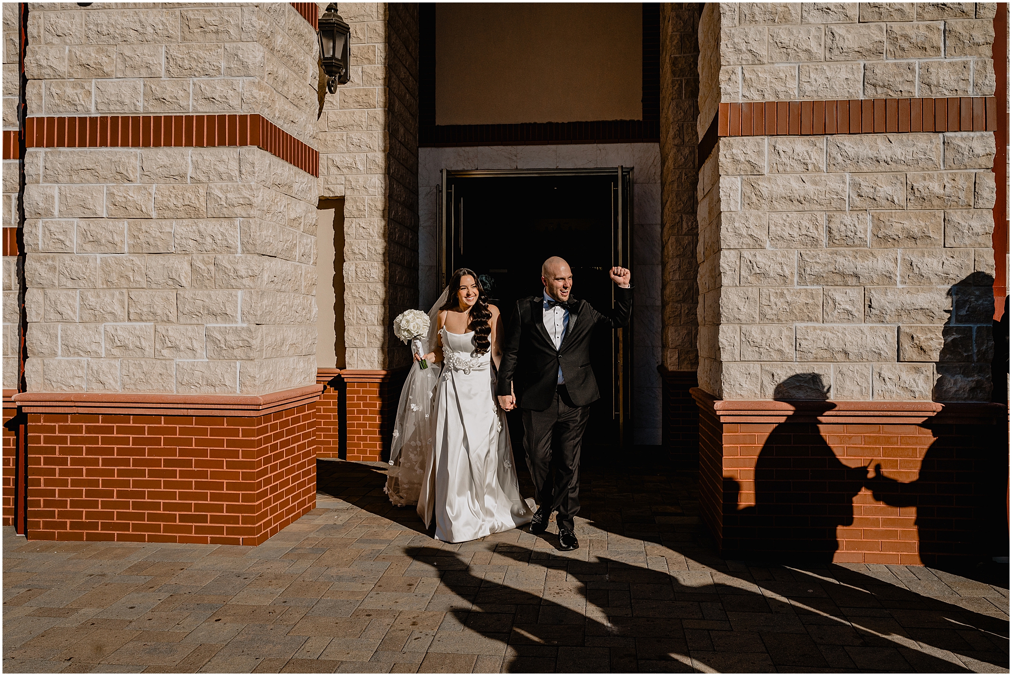 bride and groom cheer leaving church in New Jersey 