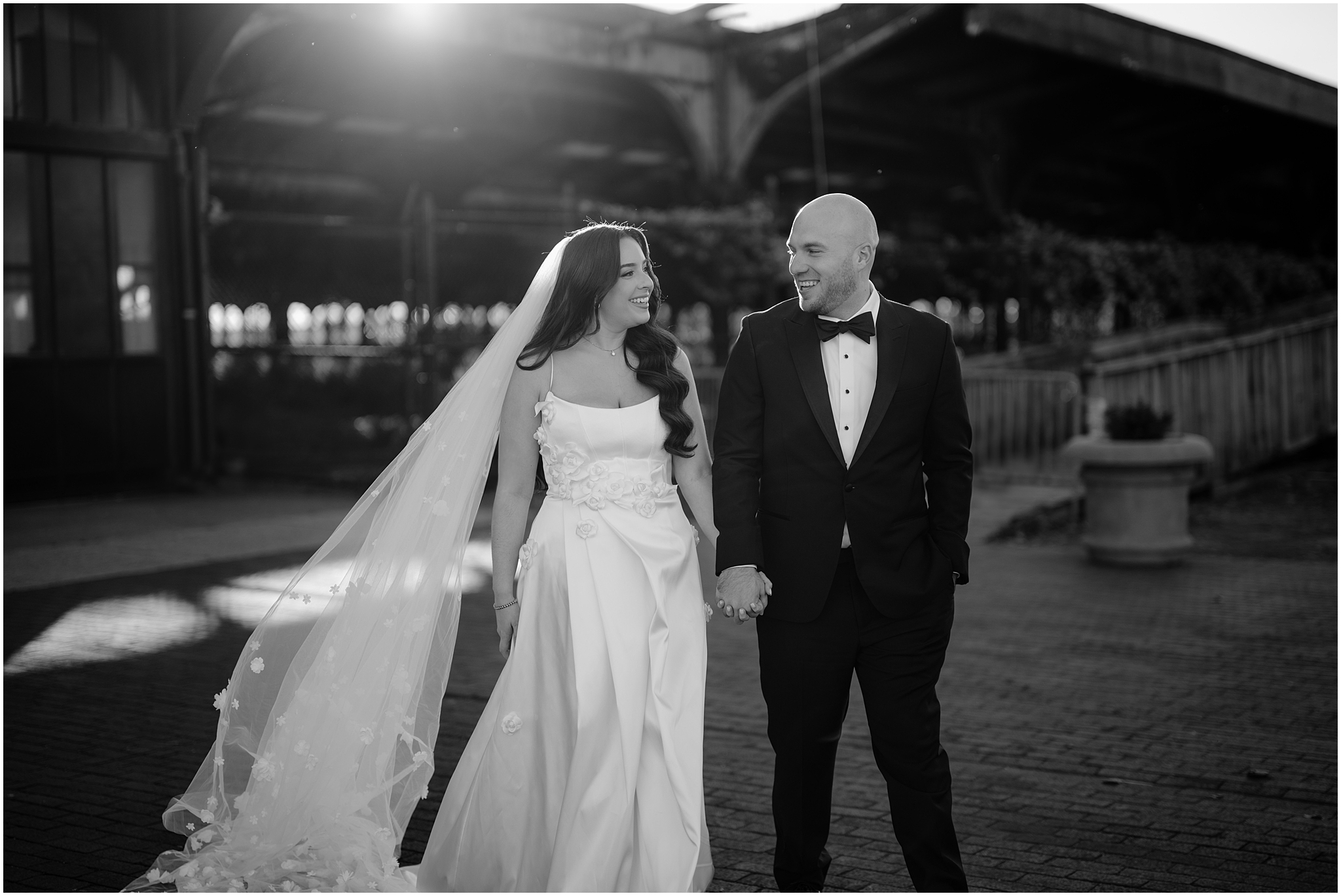 couple holds hands laughing and walking together outside the Liberty House Restaurant