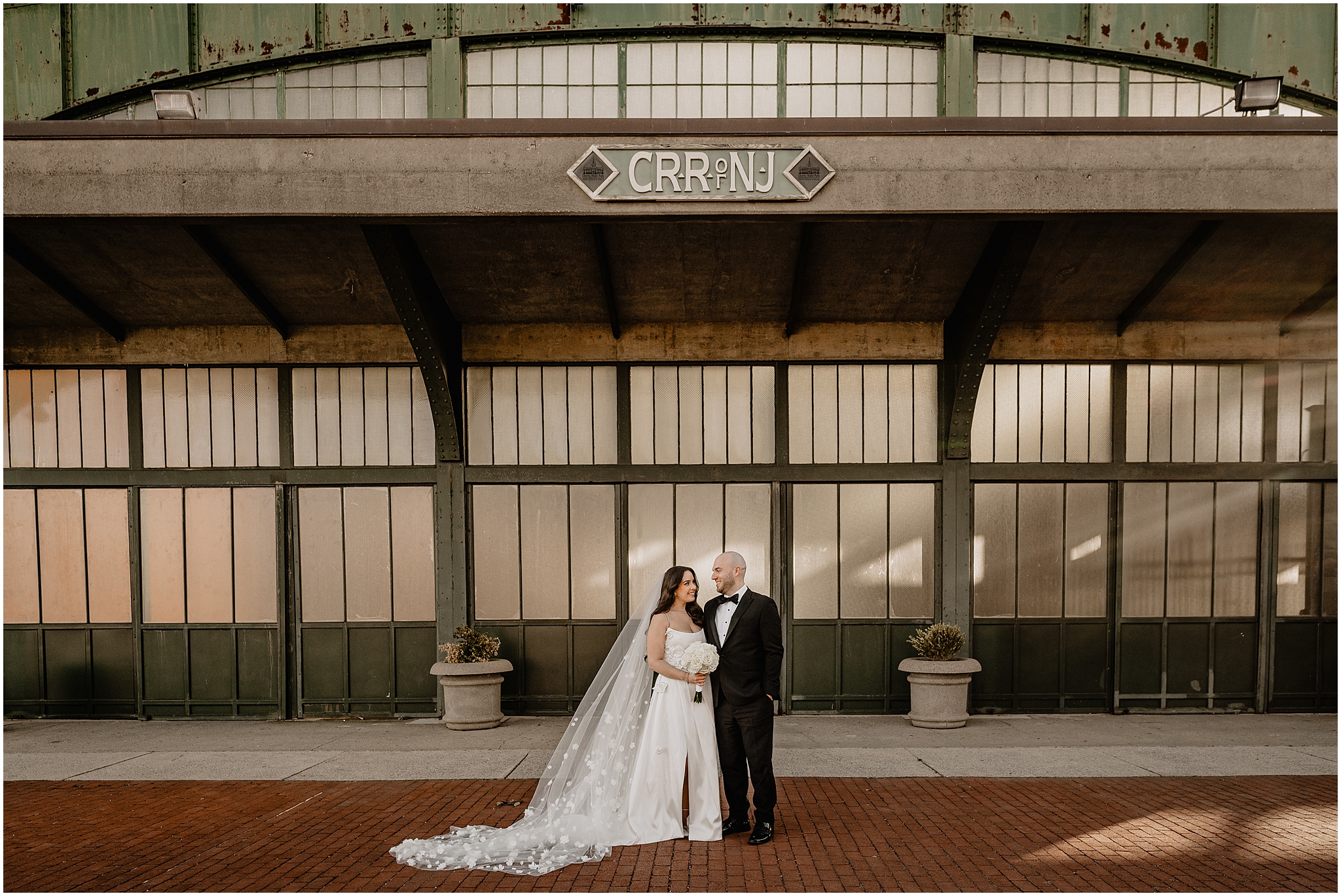 newlyweds hold hands in front of railroad house of New Jersey 