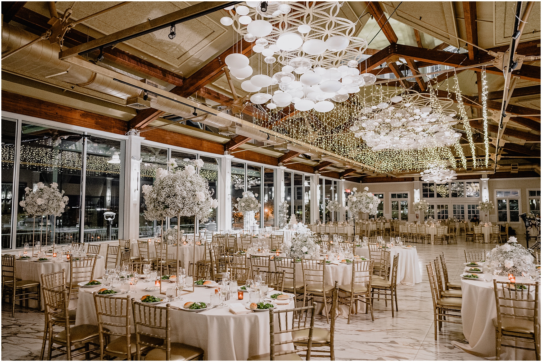 wedding reception at the Liberty House Restaurant with ivory rose and baby's breath tall centerpieces 