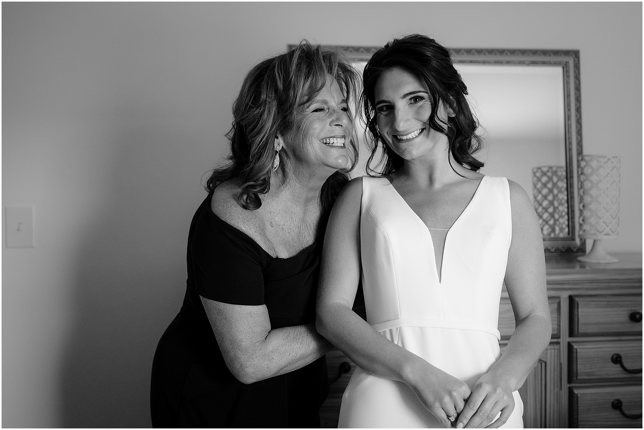 mother grins hugging bride during prep for New Jersey wedding day