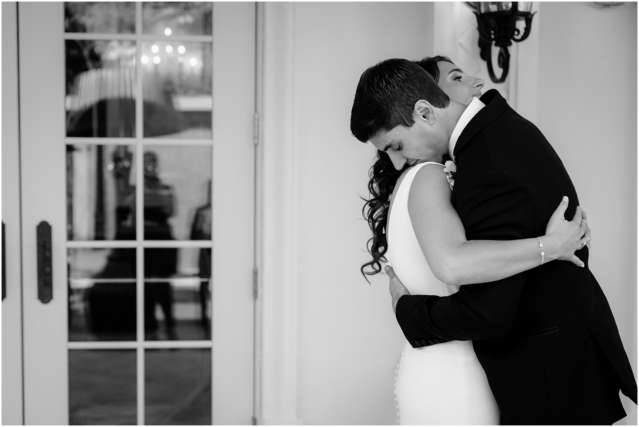 newlyweds hug on patio at The Shadowbrook at Shrewsbury during first look