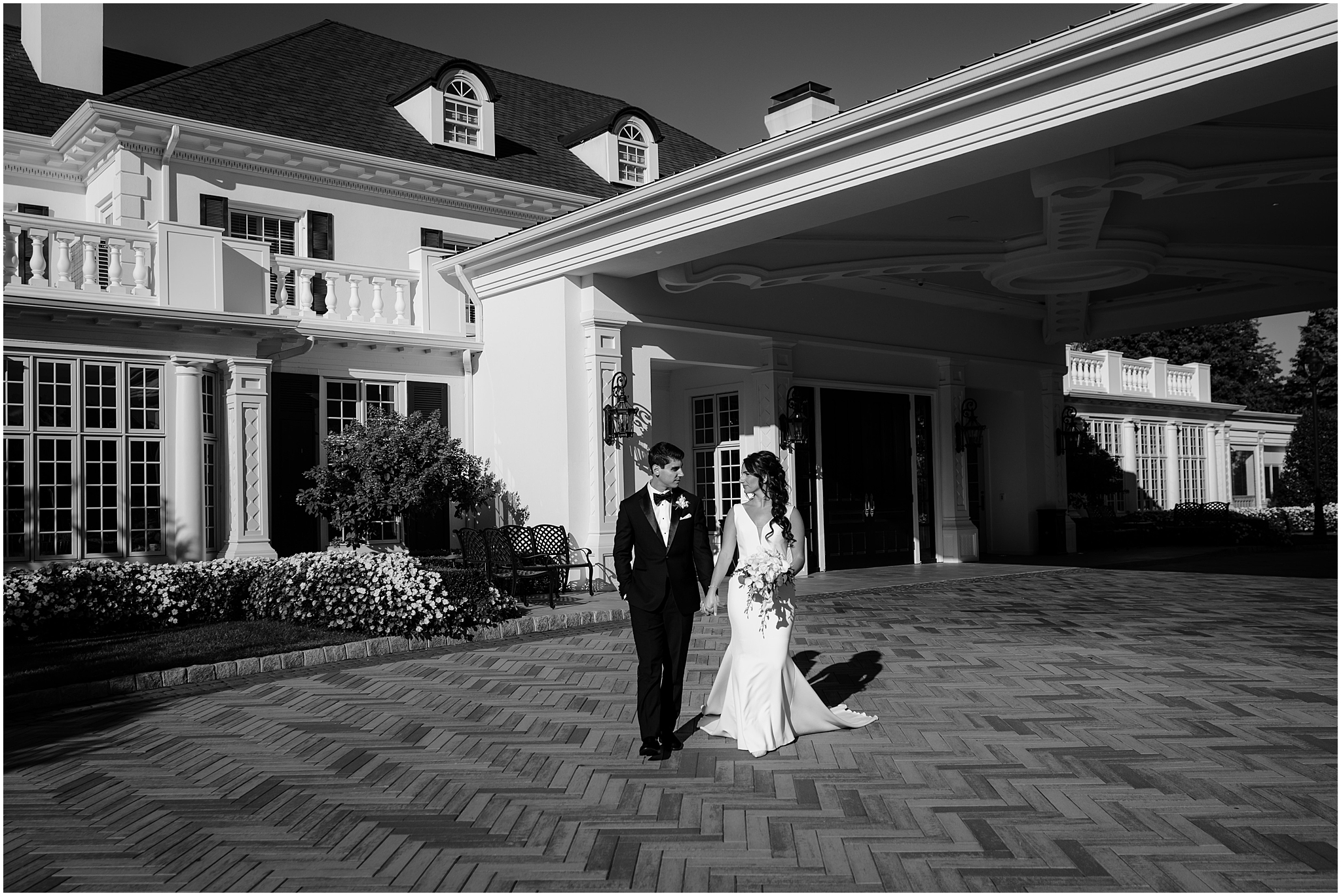 bride and groom hold hands walking in front of The Shadowbrook at Shrewsbury