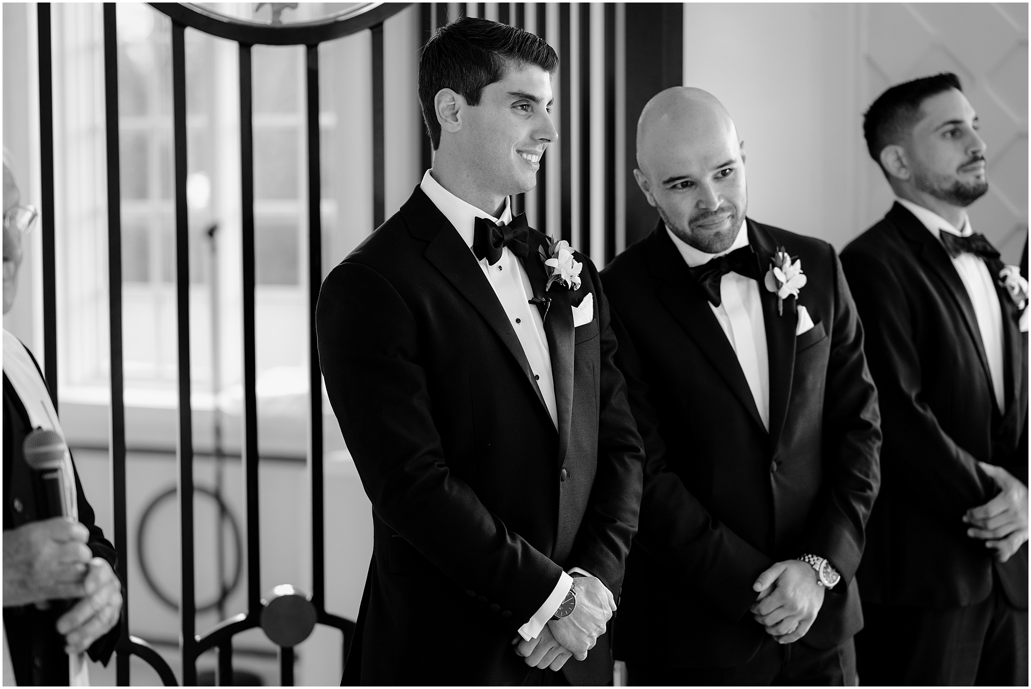 groom grins watching bride walk down aisle for wedding ceremony in New Jersey 