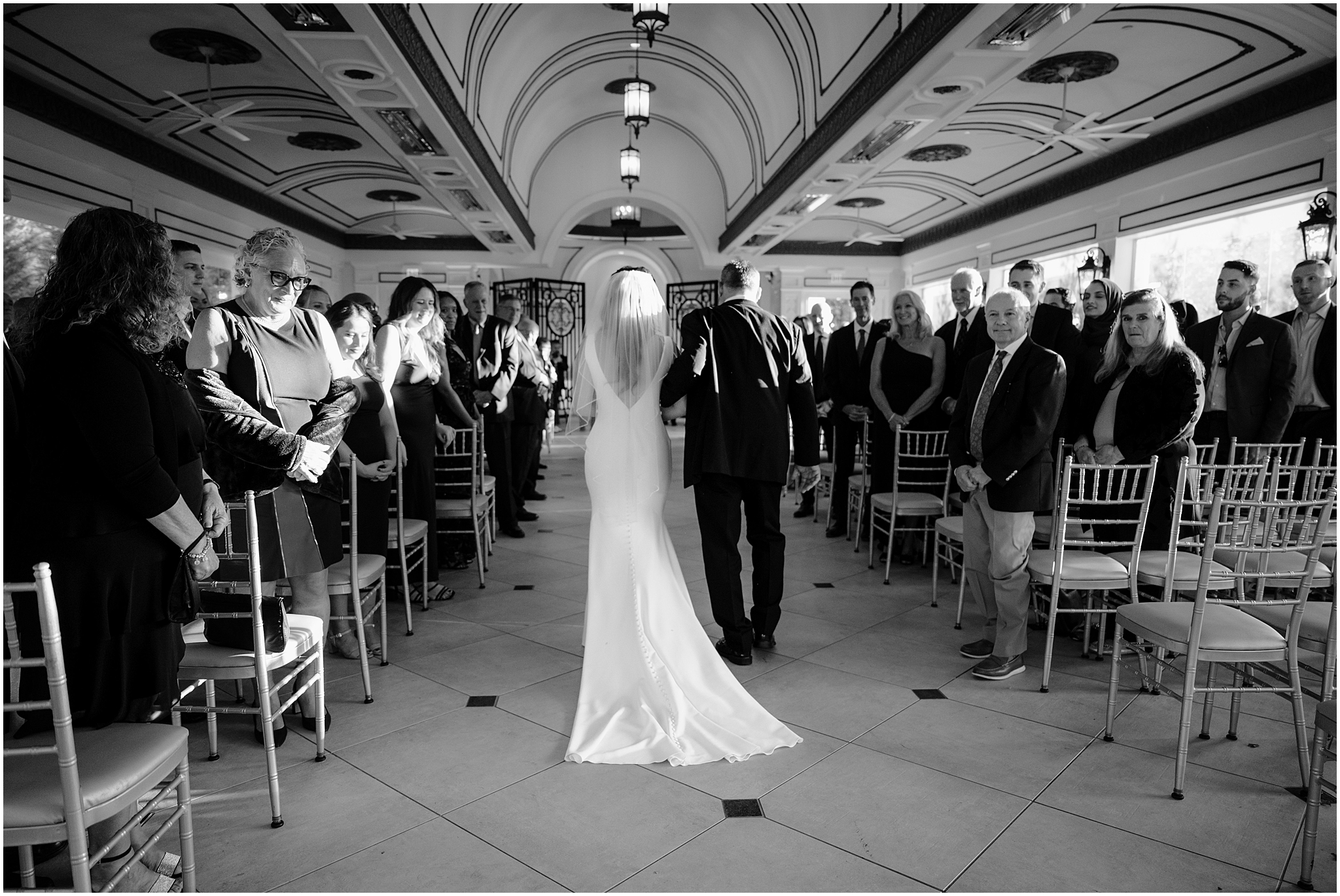 father escorts bride down aisle in ballroom at The Shadowbrook at Shrewsbury