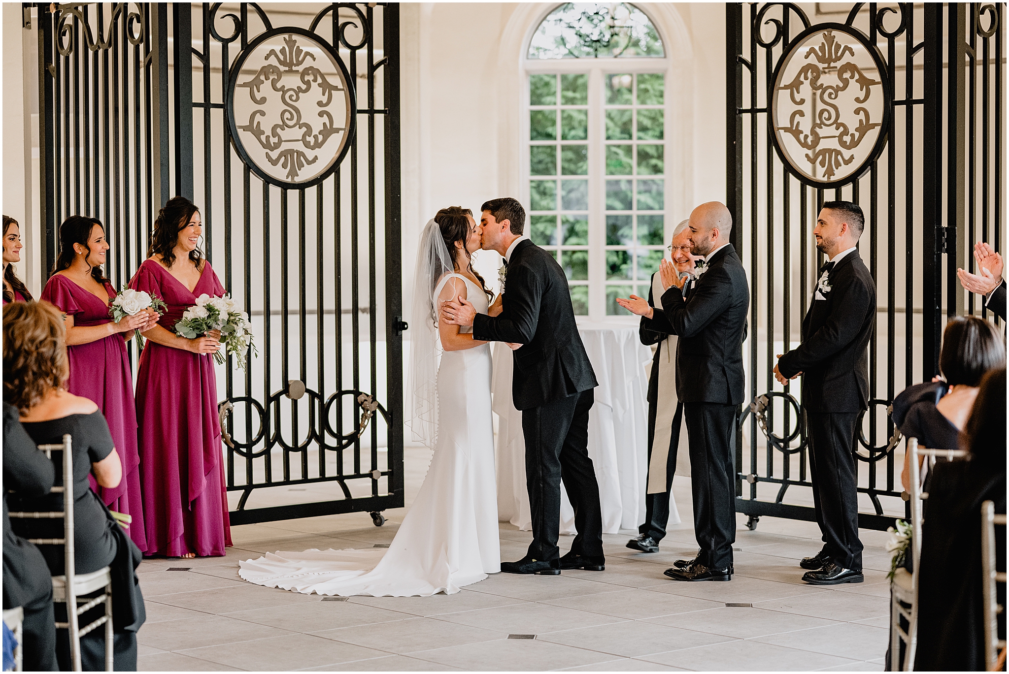 bride and groom kiss by gold and black dividers at The Shadowbrook at Shrewsbury