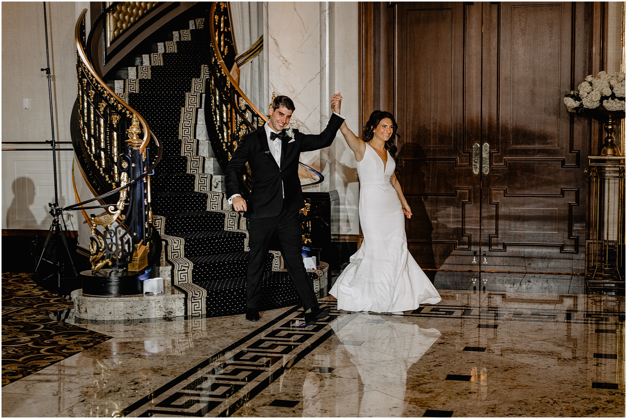 bride and groom cheer entering ballroom for wedding reception at The Shadowbrook at Shrewsbury