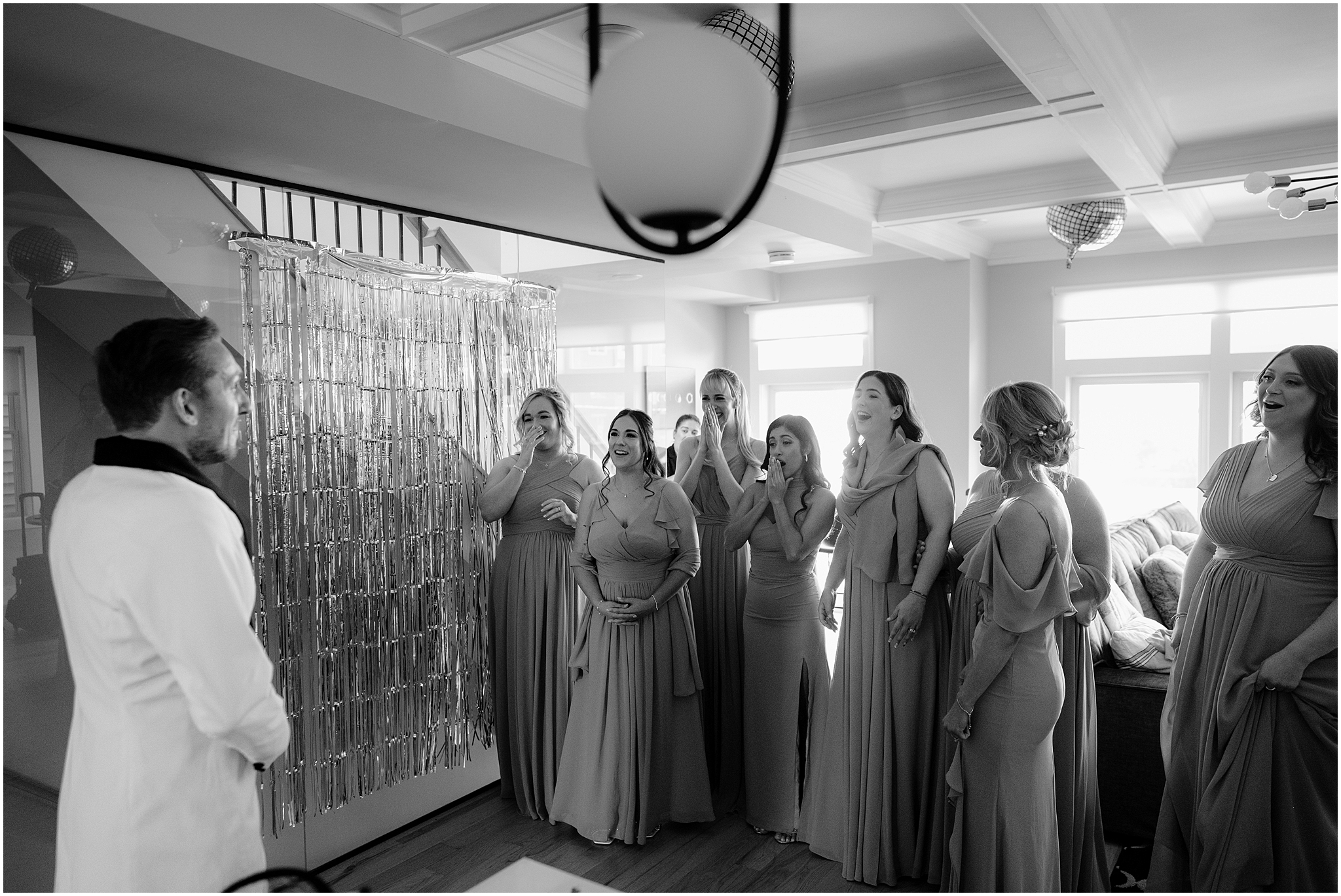 bridesmaids react to groom's custom look for wedding day in white suit jacket 