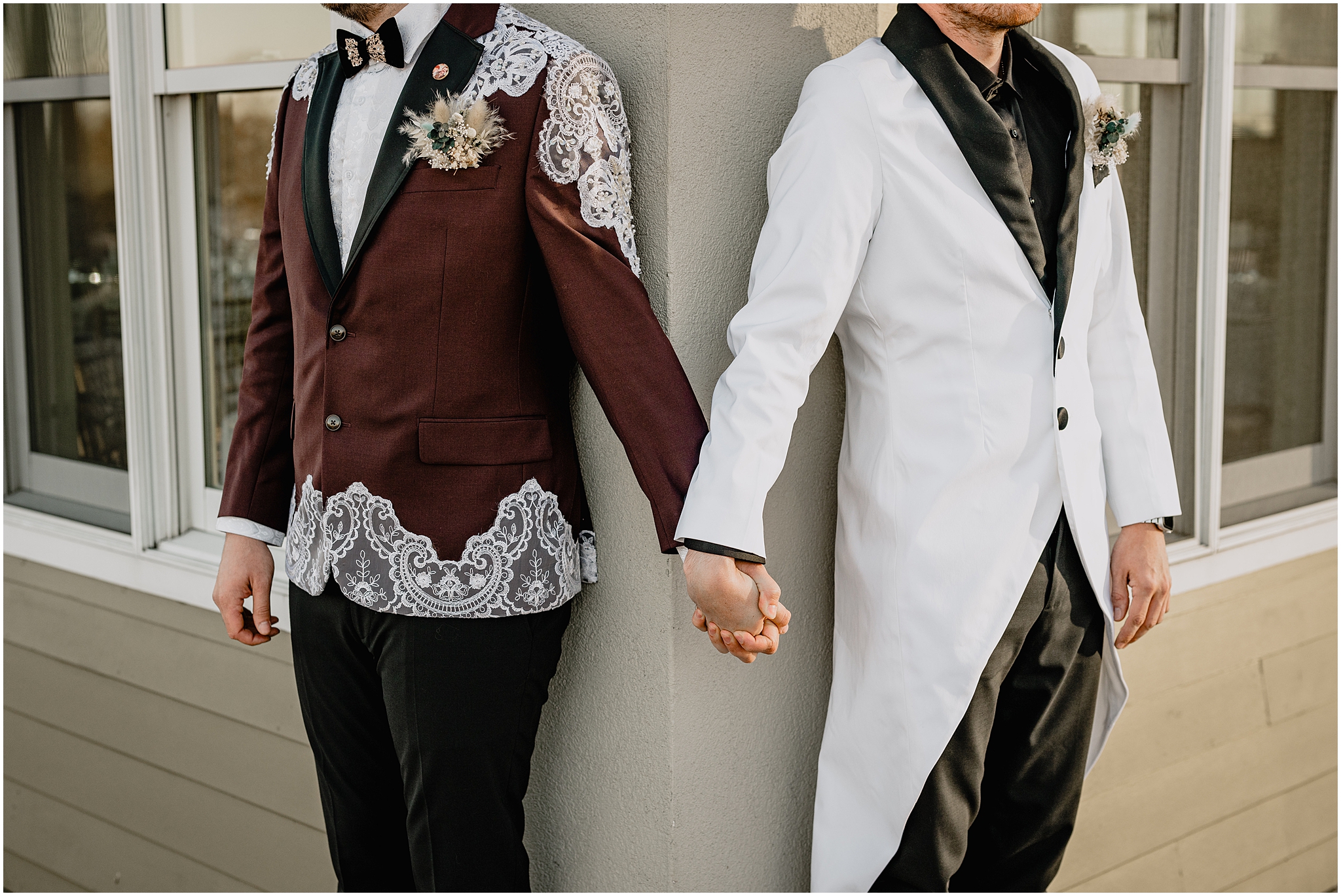two grooms hold hands around corner of the Liberty House in Jersey City