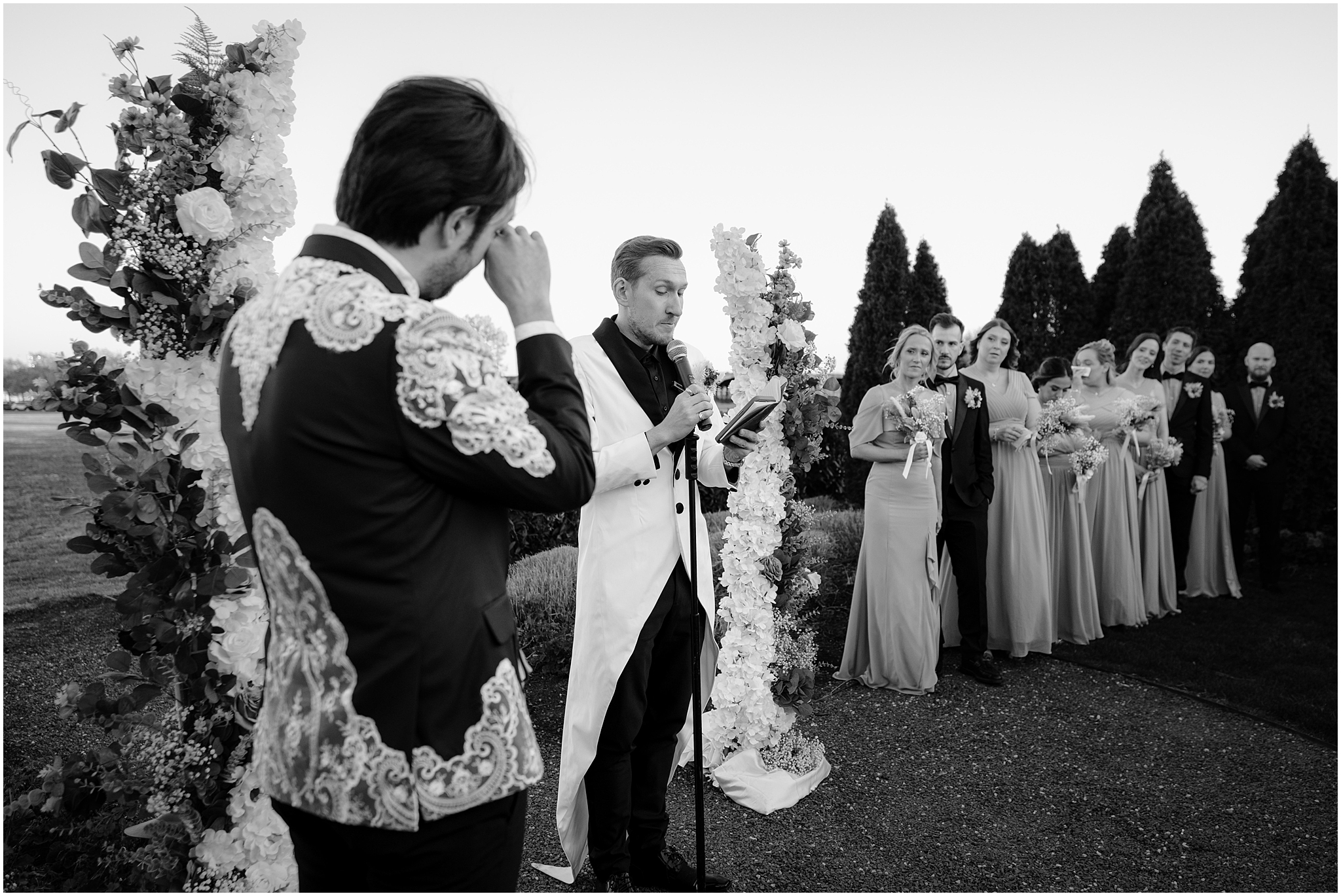 man reads speech to husband during wedding ceremony on the lawn at the Liberty House in Jersey City