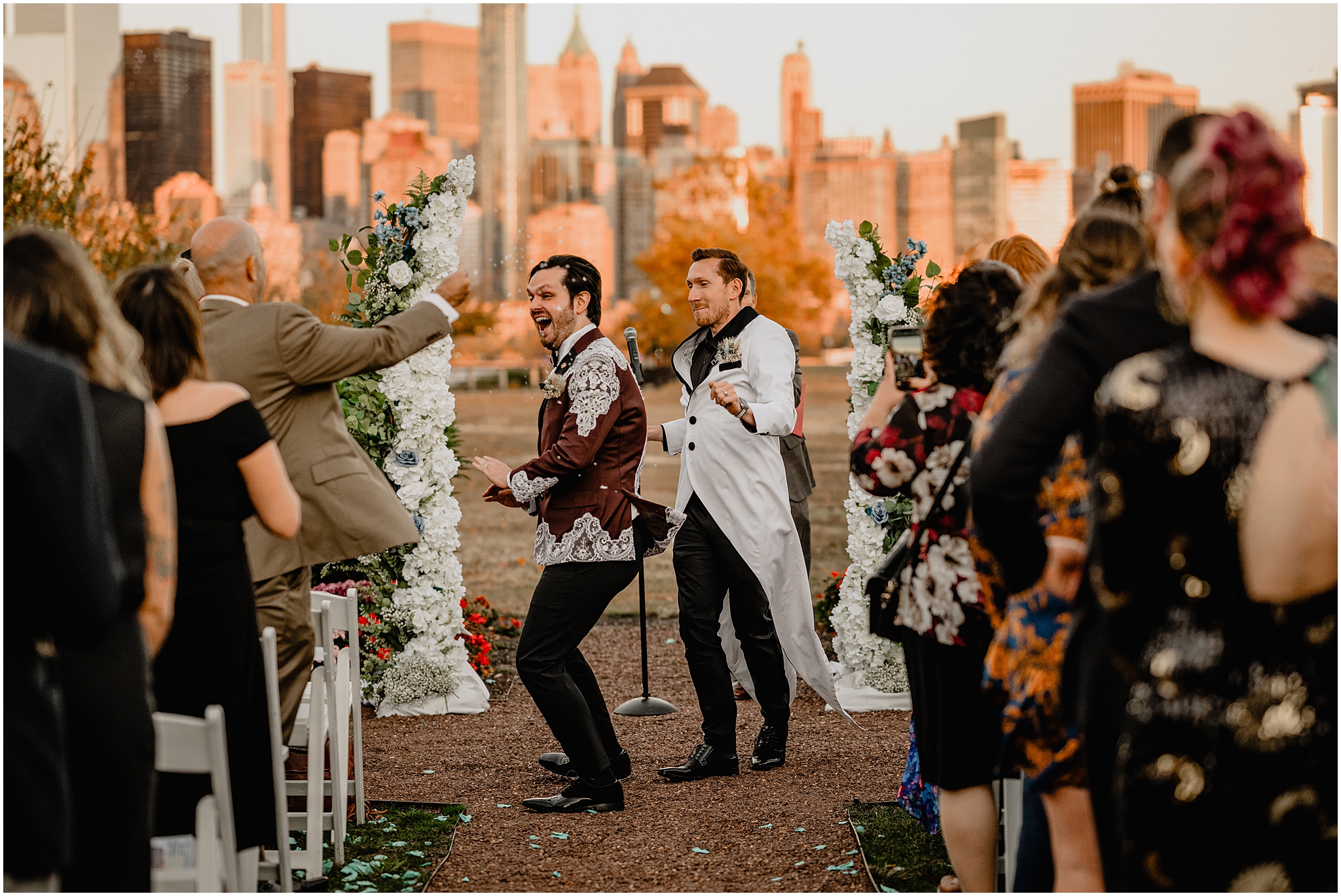two grooms dance and walk up aisle at the Liberty House in Jersey City