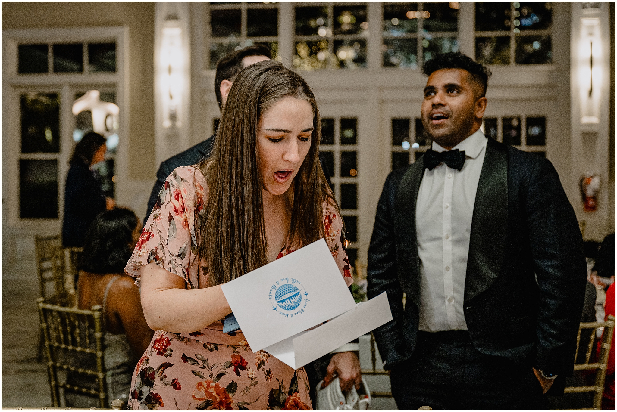 woman opens card during reception at the Liberty House in Jersey City