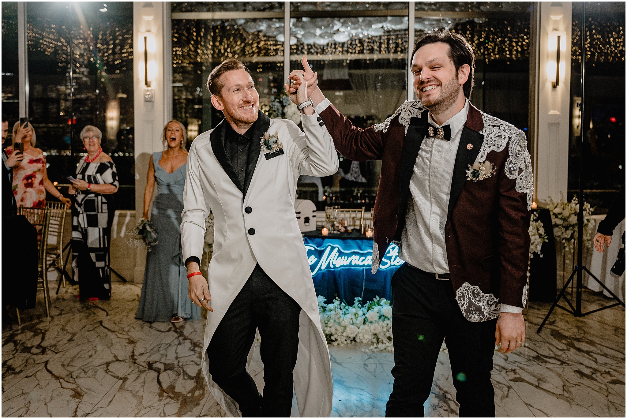 men hold hands walking into ballroom at the Liberty House in Jersey City