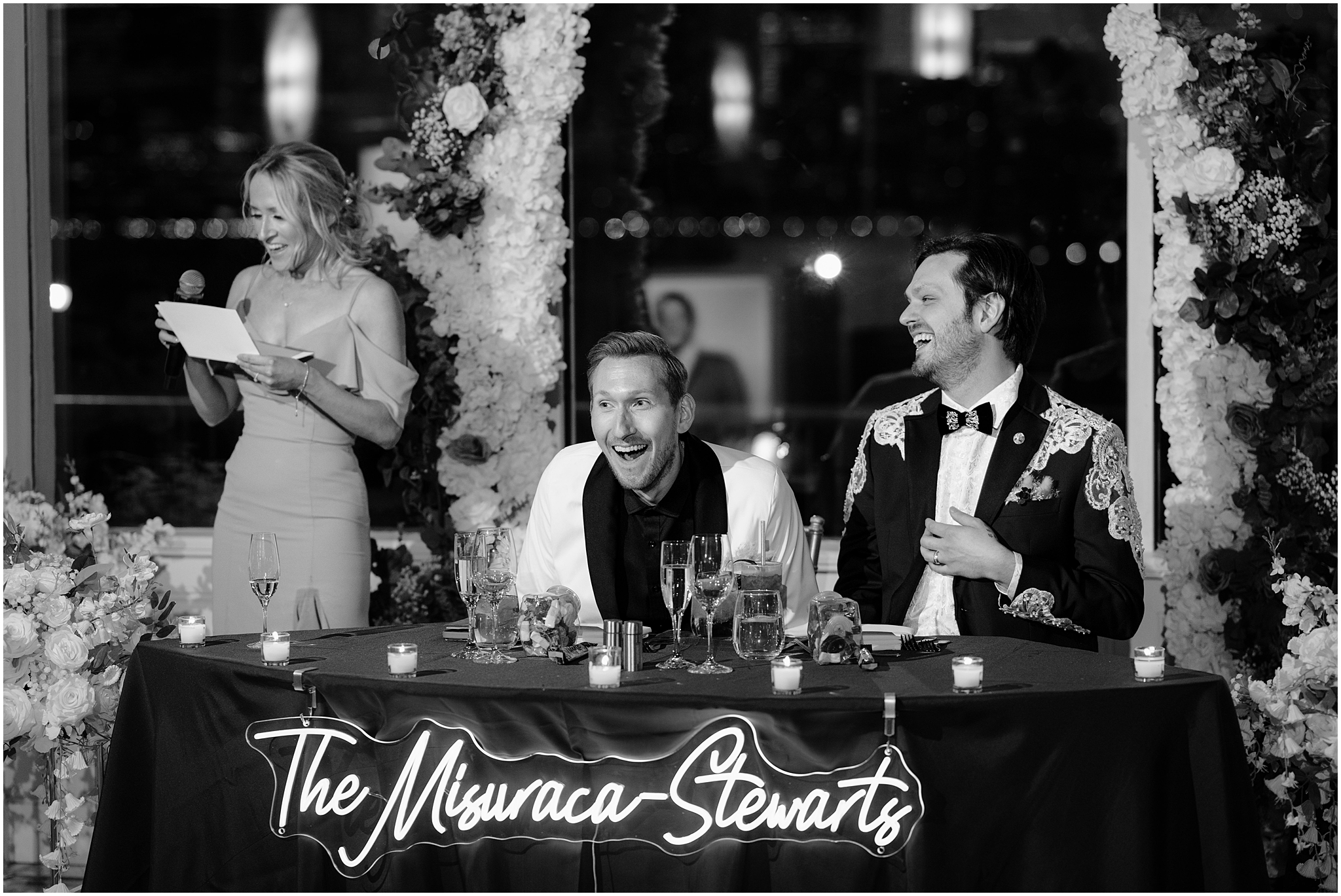 couple laughs while mother reads speech during wedding reception at the Liberty House in Jersey City