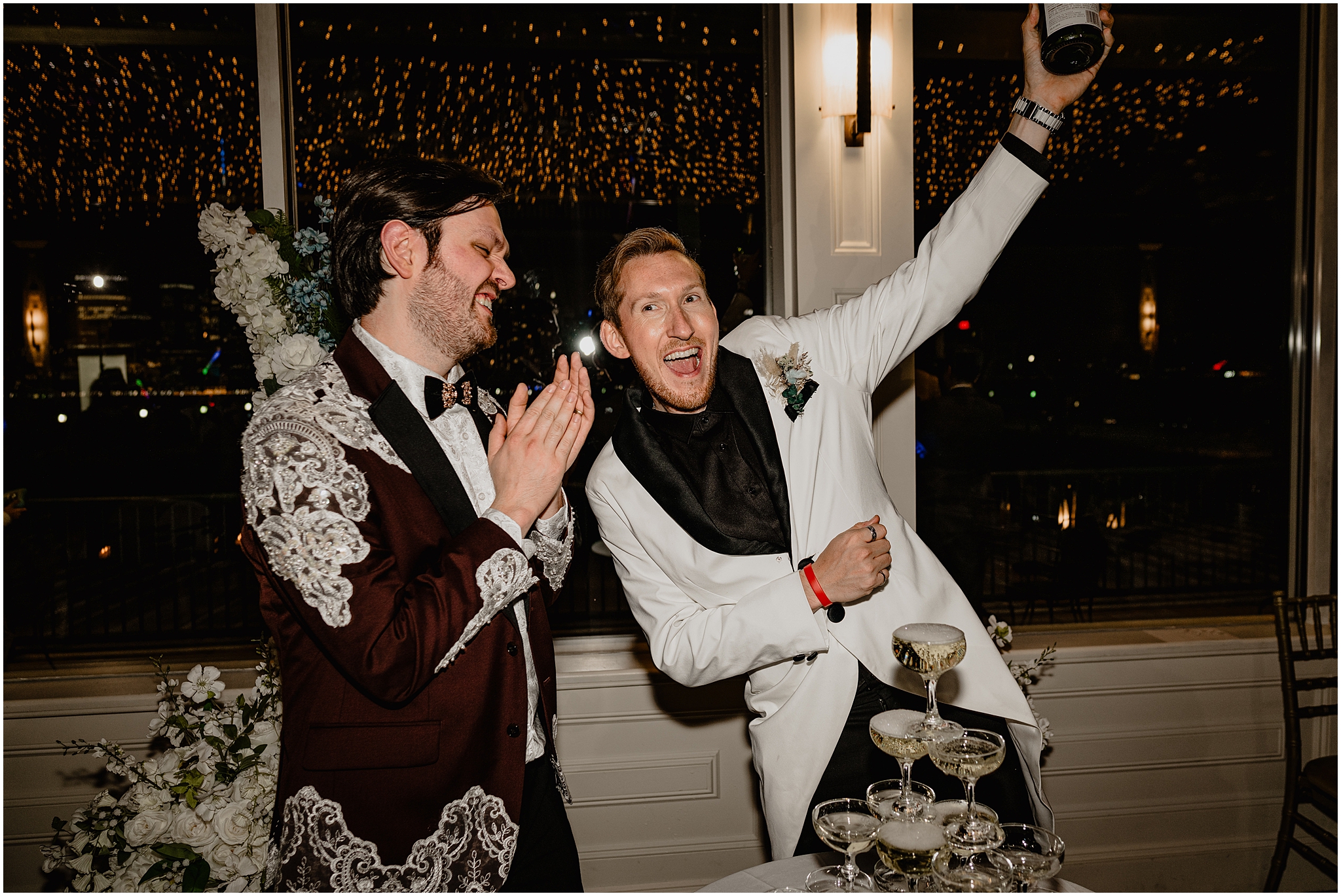 grooms laugh after champagne tower at the Liberty House in Jersey City