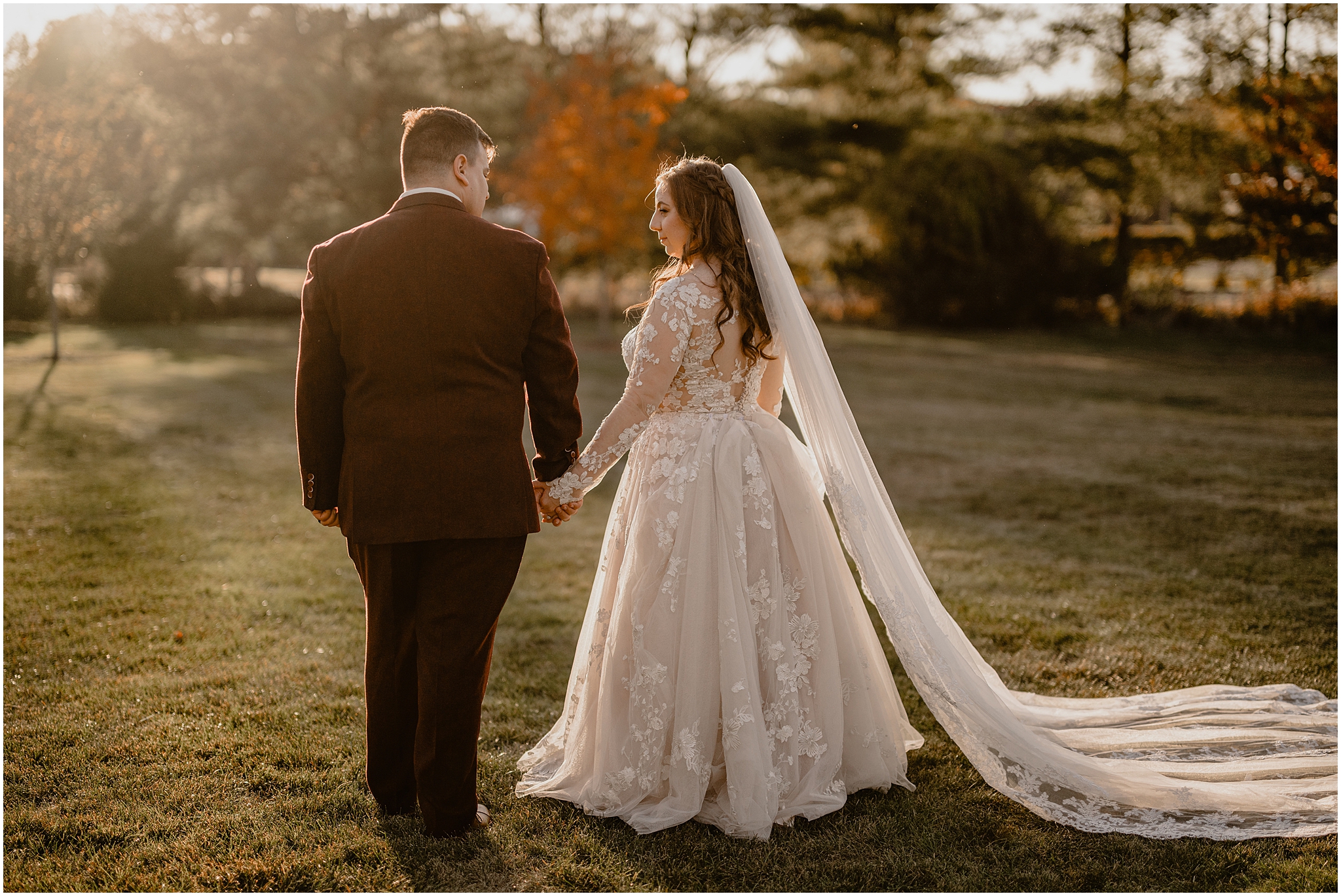 bride and groom hold hands standing on lawn at the Barn at Perona Farms