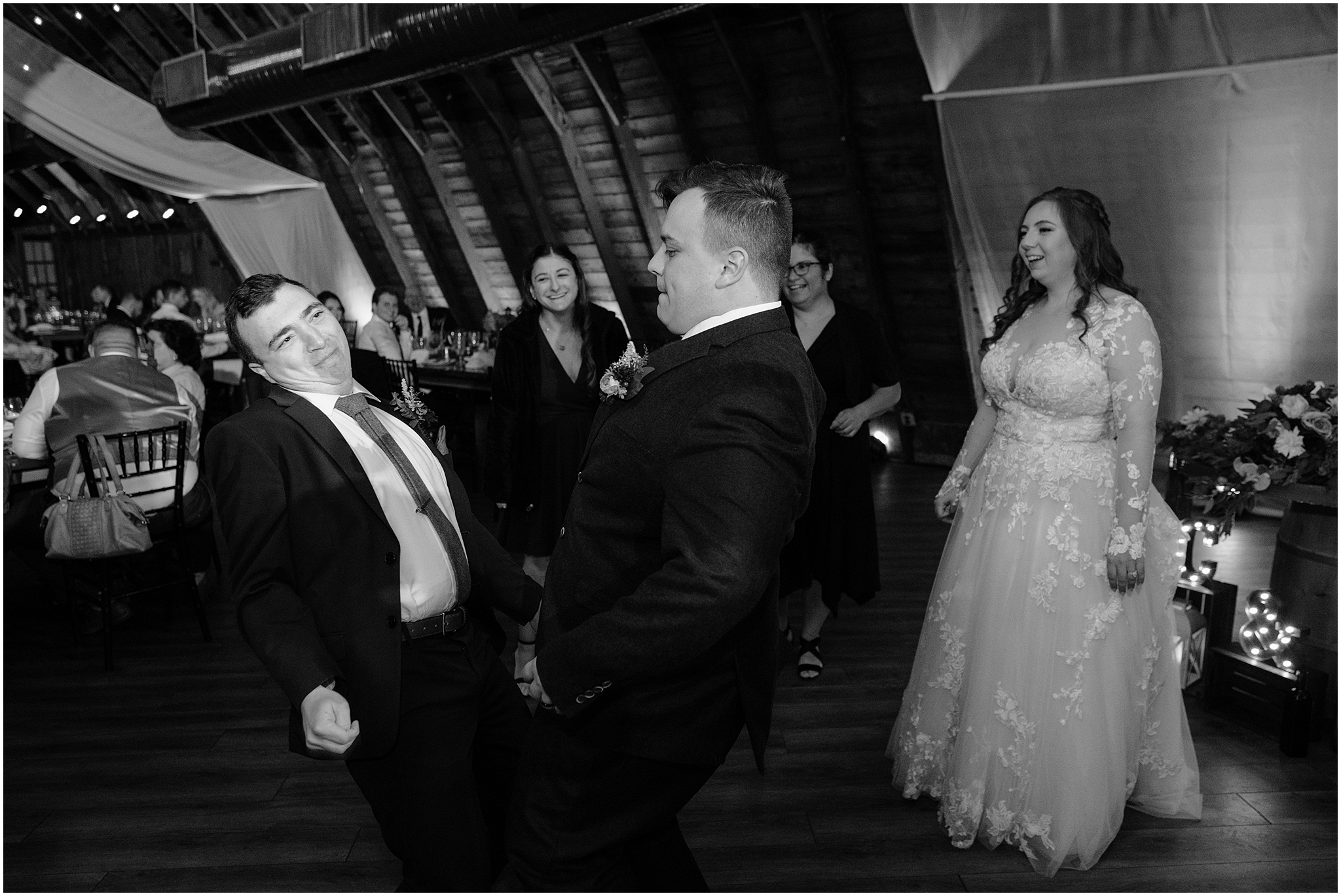 groomsmen dance in the Barn at Perona Farms