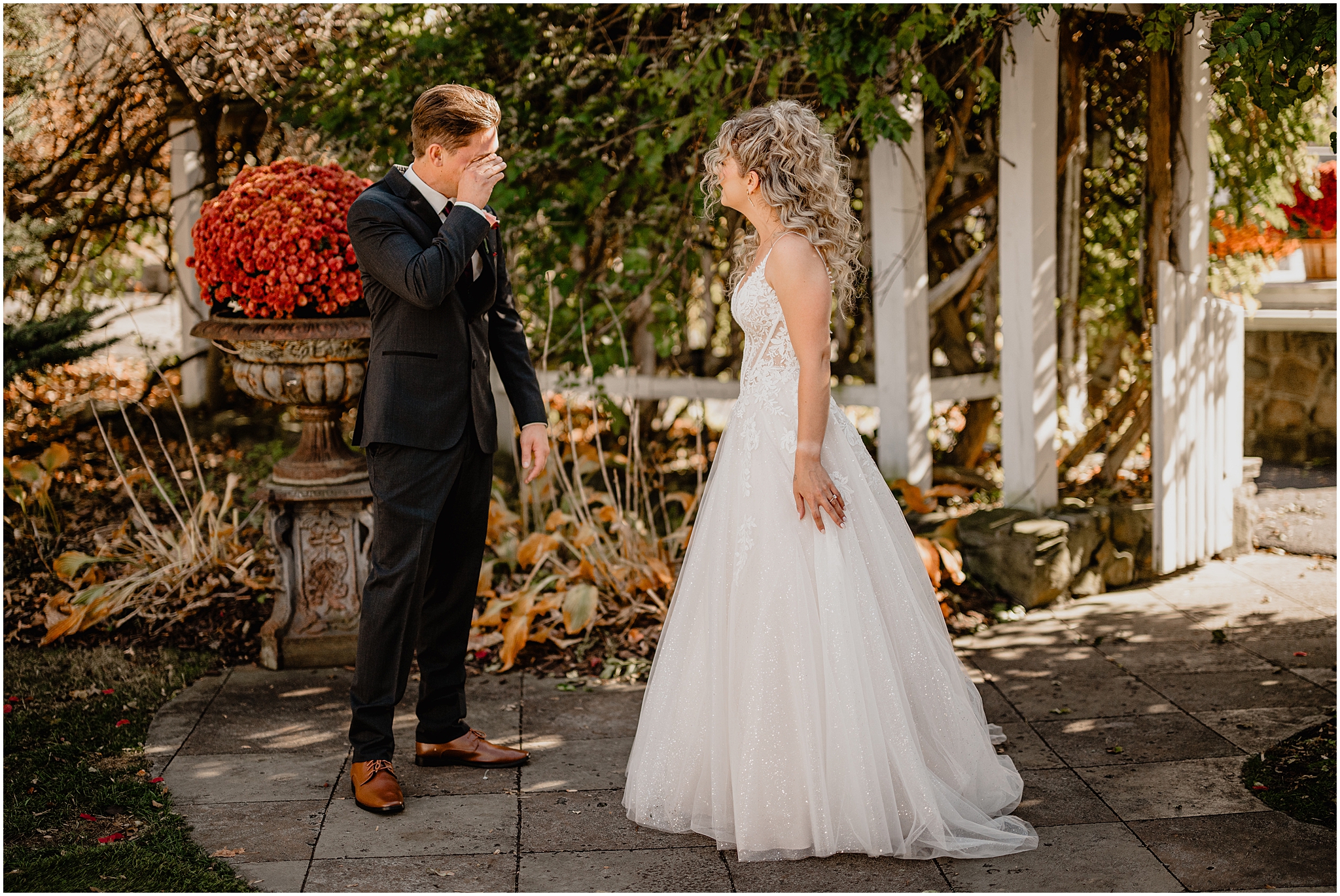 groom cries while seeing bride during first look on fall wedding day