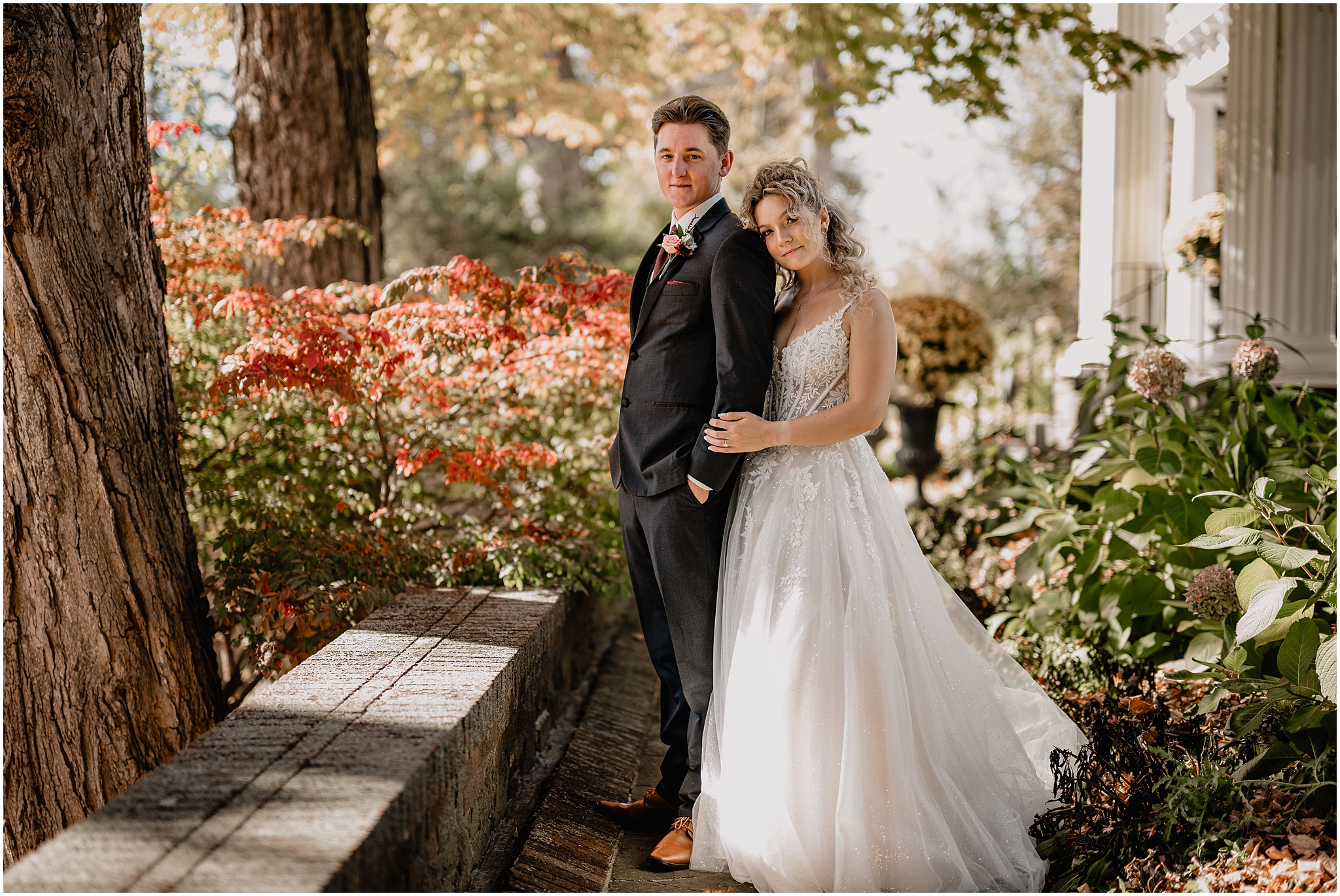 bride leans head on groom's shoulder from behind standing in the gardens of Hudson Valley wedding venue the Feast at Round Hill