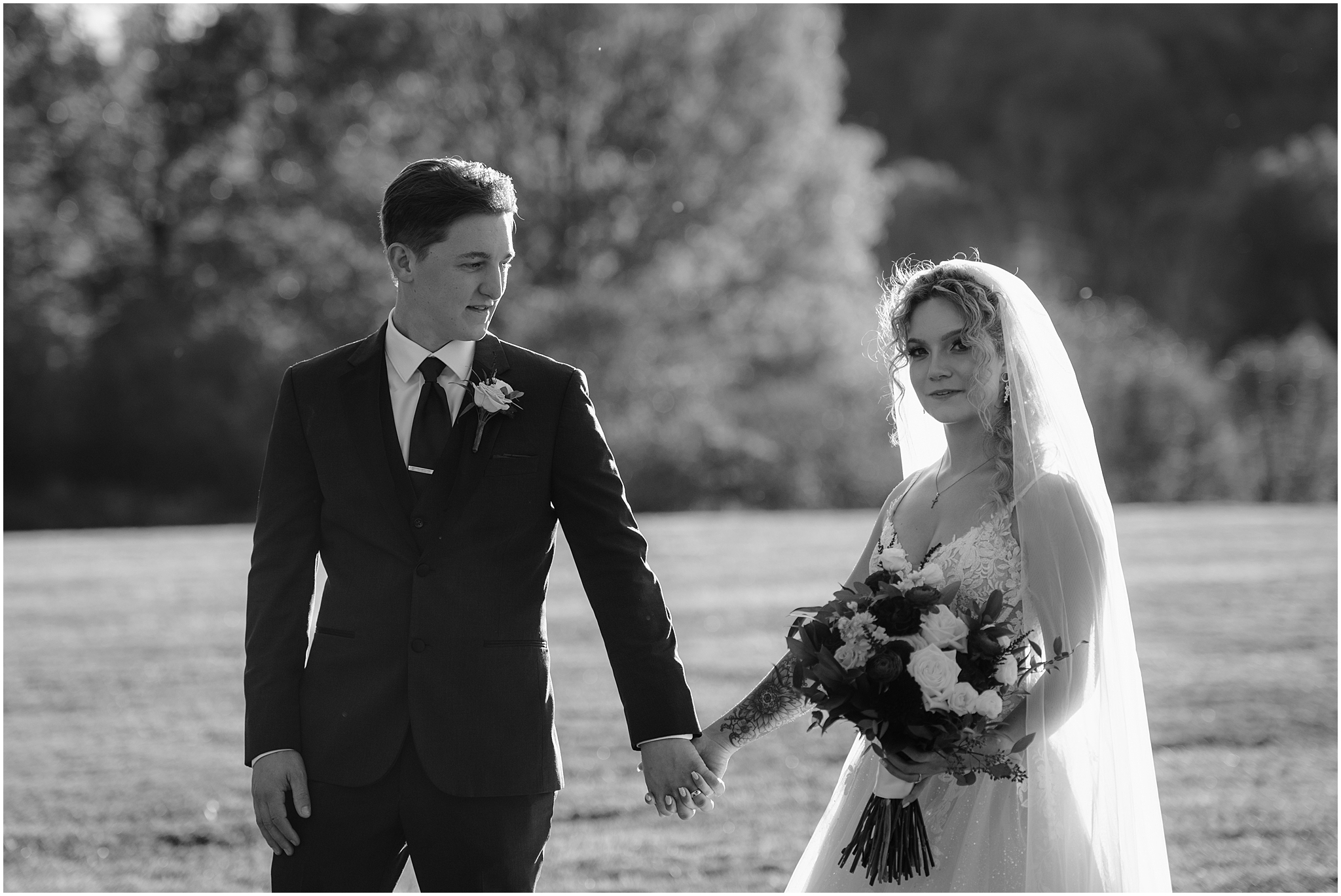 bride and groom hold hands on lawn of Hudson Valley wedding venue 