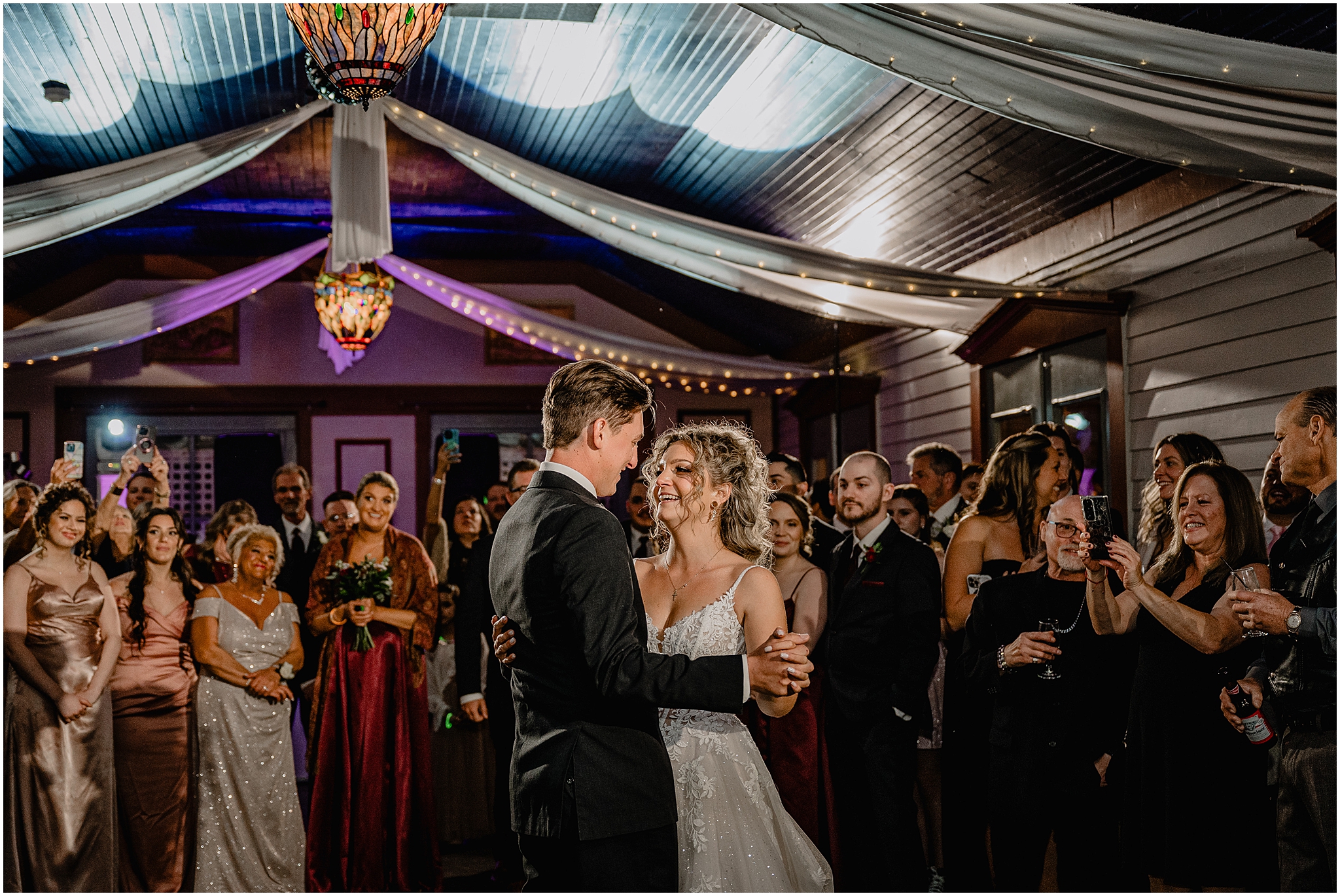 newlyweds smile at each other during first dance at wedding reception at the Feast at Round Hill