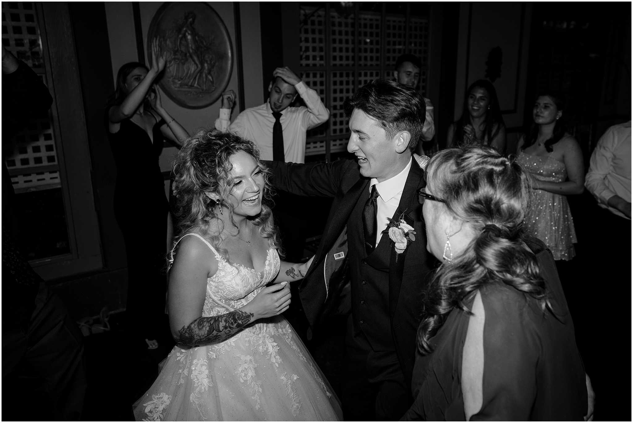 bride and groom grin singing with wedding guest during reception at the Feast at Round Hill