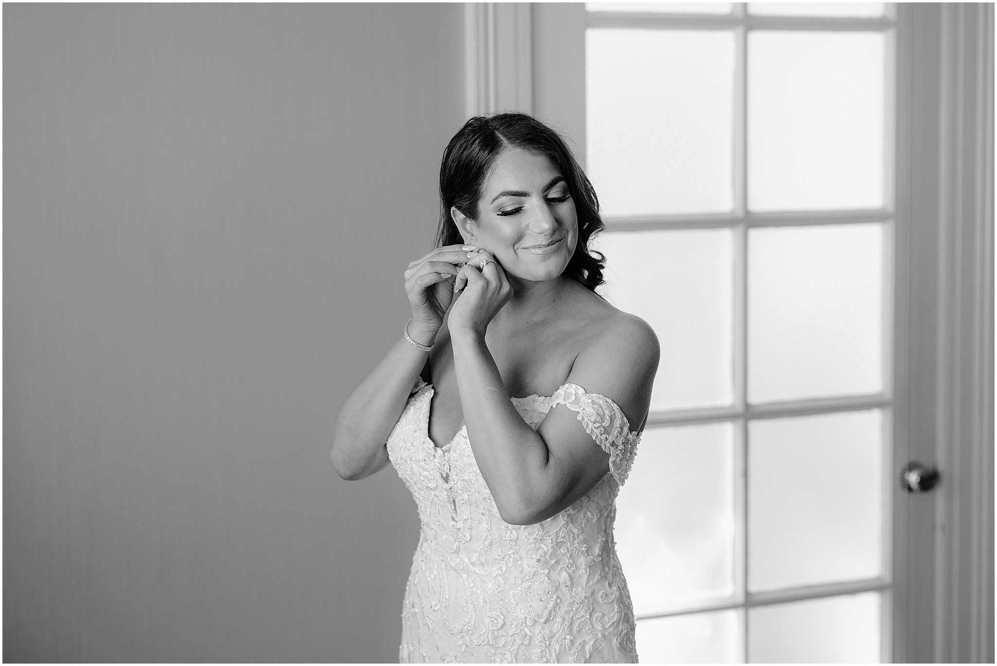 bride adjusts earrings during bridal prep at Tappan Hill Mansion