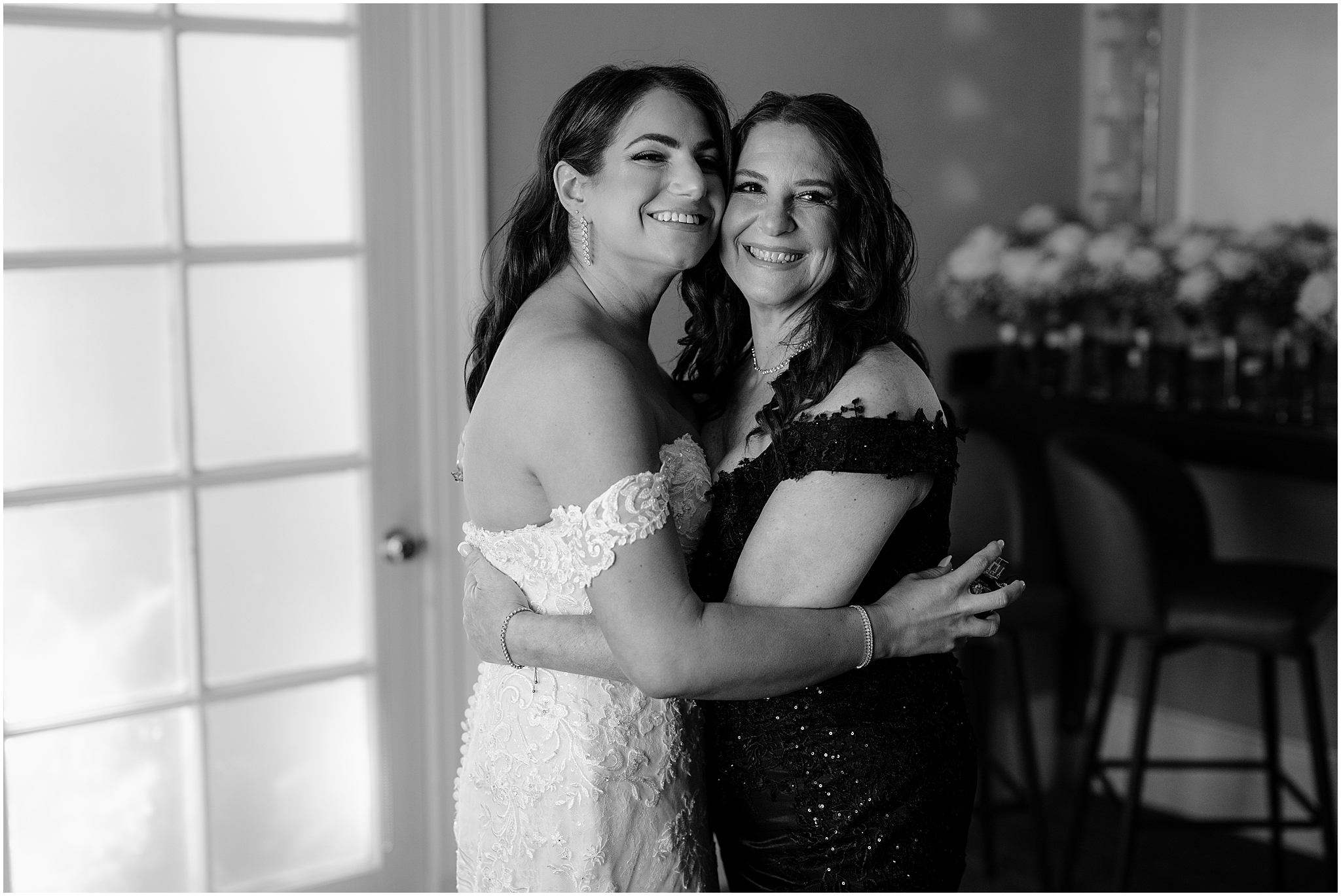 bride hugs mother near window inside Tappan Hill Mansion