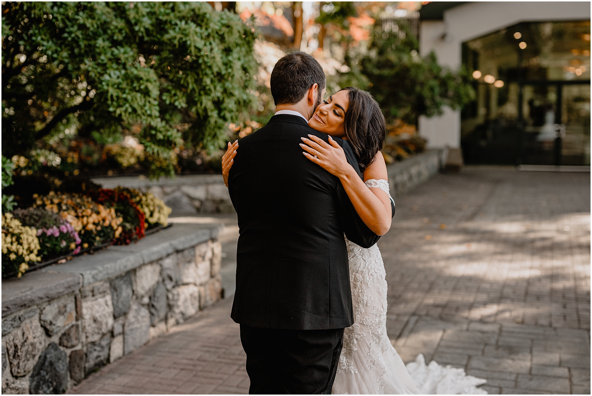 bride hugs groom during first look outside Tappan Hill Mansion