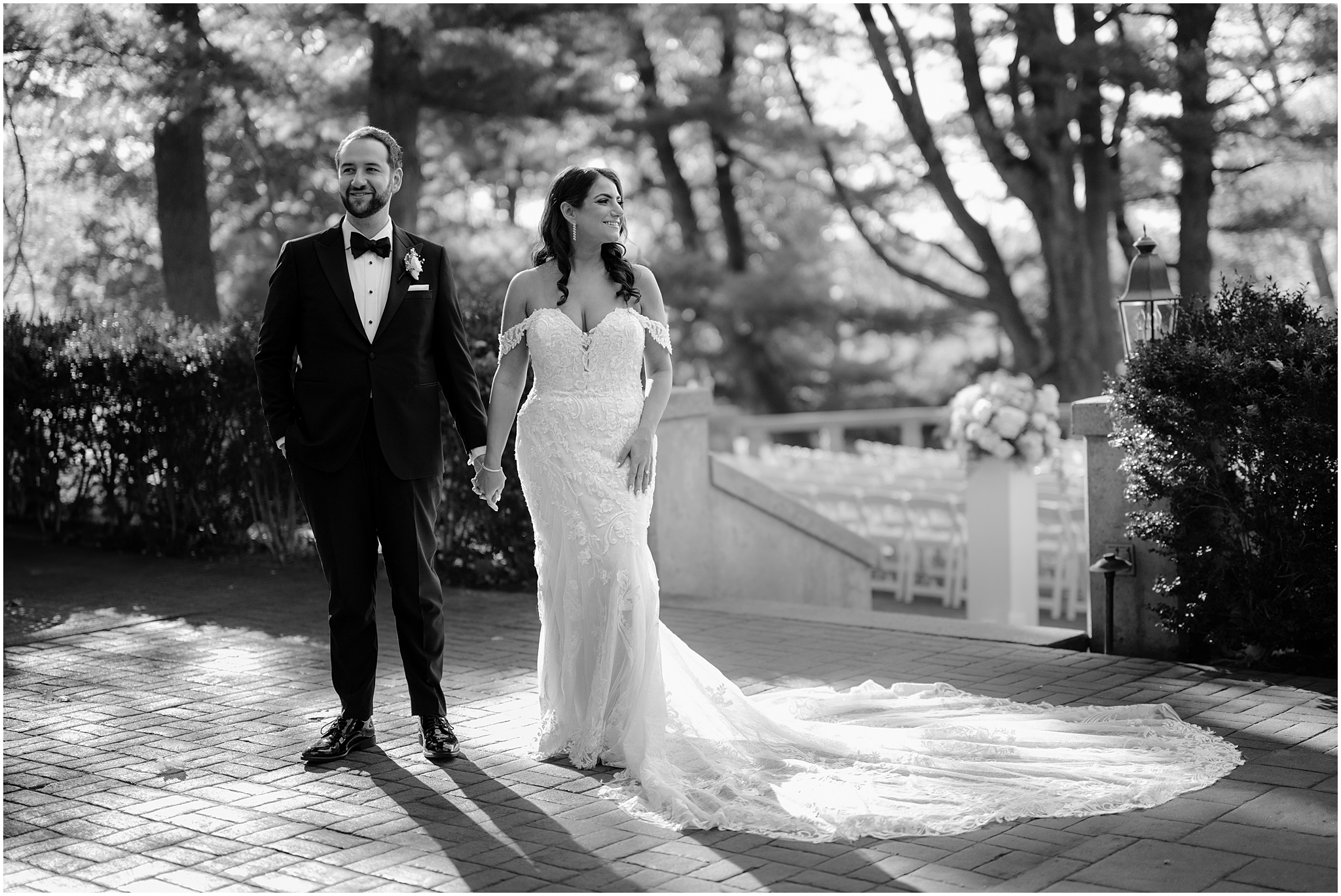 bride and groom hold hands standing on brick patio at Tappan Hill Mansion