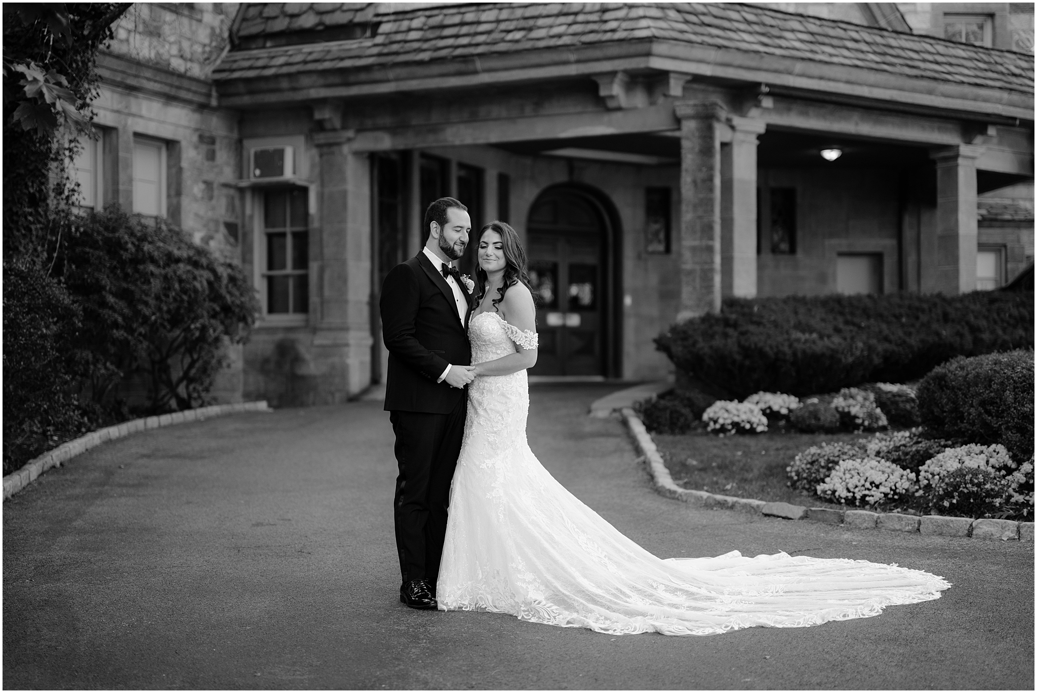 bride and groom stand together holding hands in the walkway outside Tappan Hill Mansion