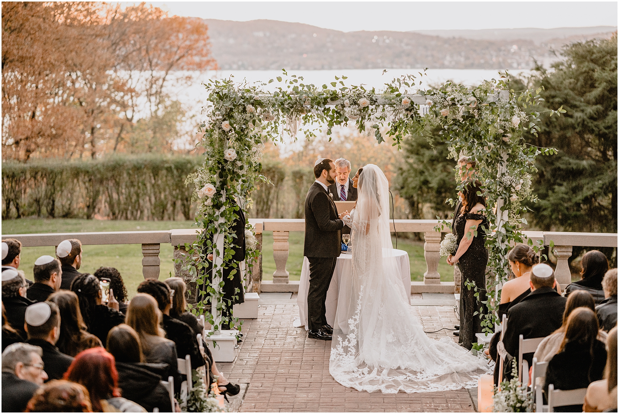 guests watch Jewish wedding ceremony on the patio at Tappan Hill Mansion