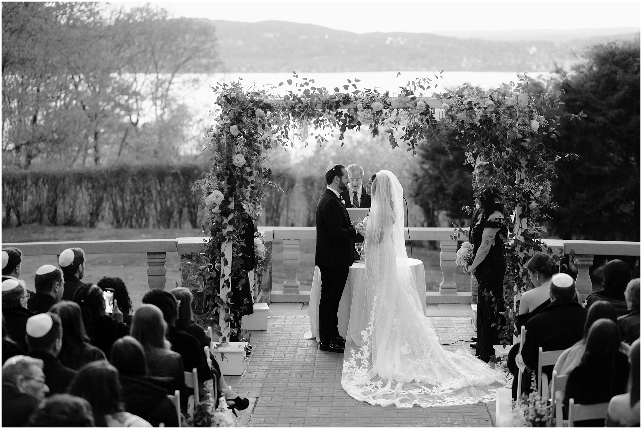 rabbi reads during Jewish wedding ceremony on the patio at Tappan Hill Mansion