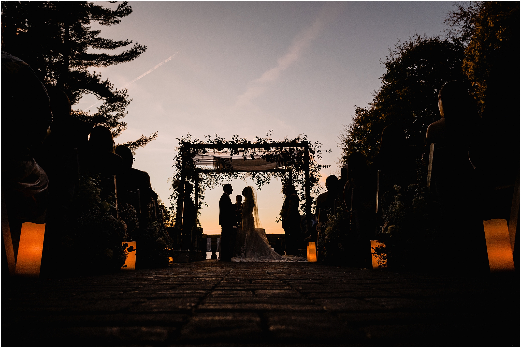 Jewish wedding ceremony on the patio at Tappan Hill Mansion at sunset