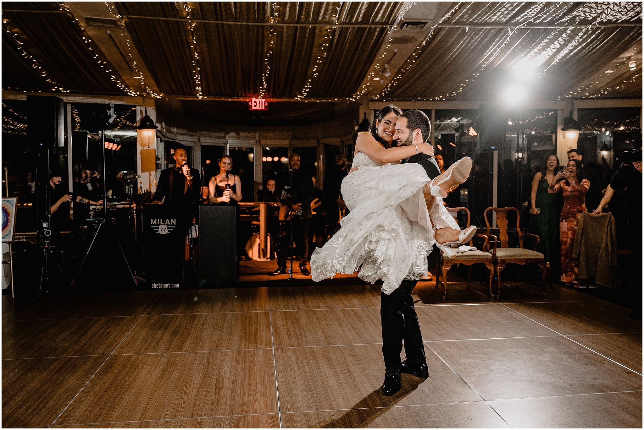 groom lifts bride and twirls her on dance floor during Tarrytown NY wedding reception