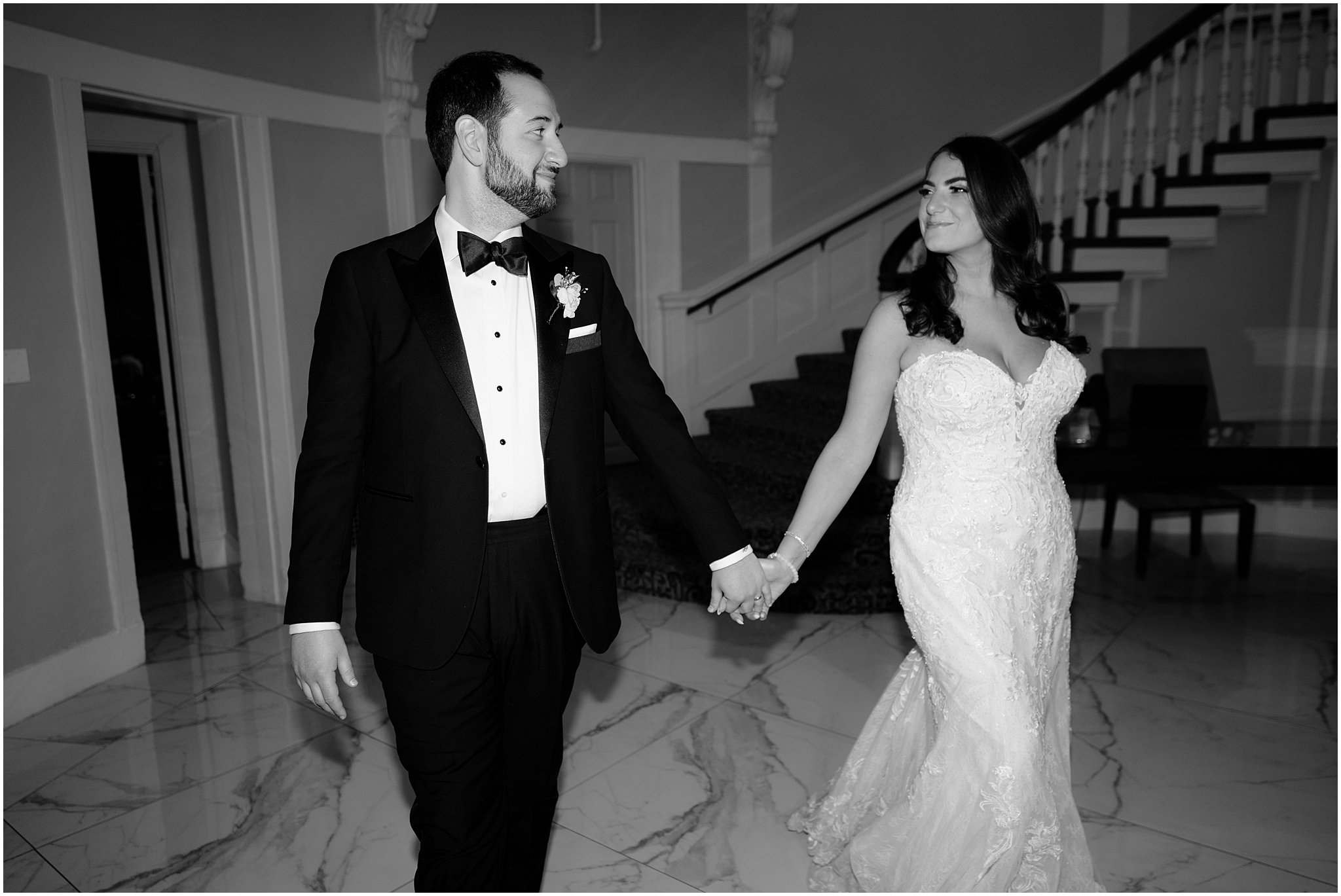 bride and groom hold hands walking through lobby at Tappan Hill Mansion