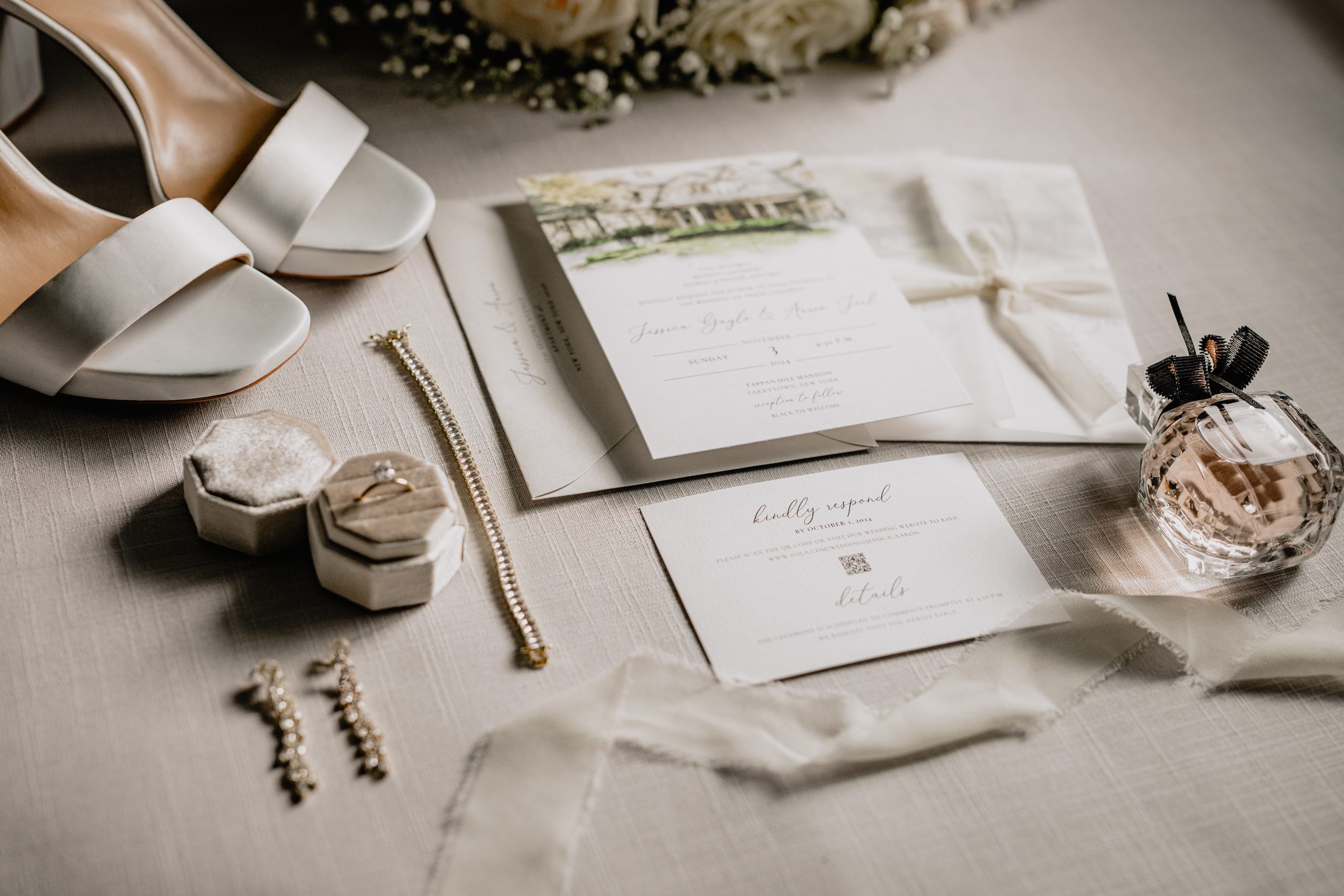 bride's ivory shoes, jewelry, and invitation suite featuring watercolor painting of Tappan Hill Mansion