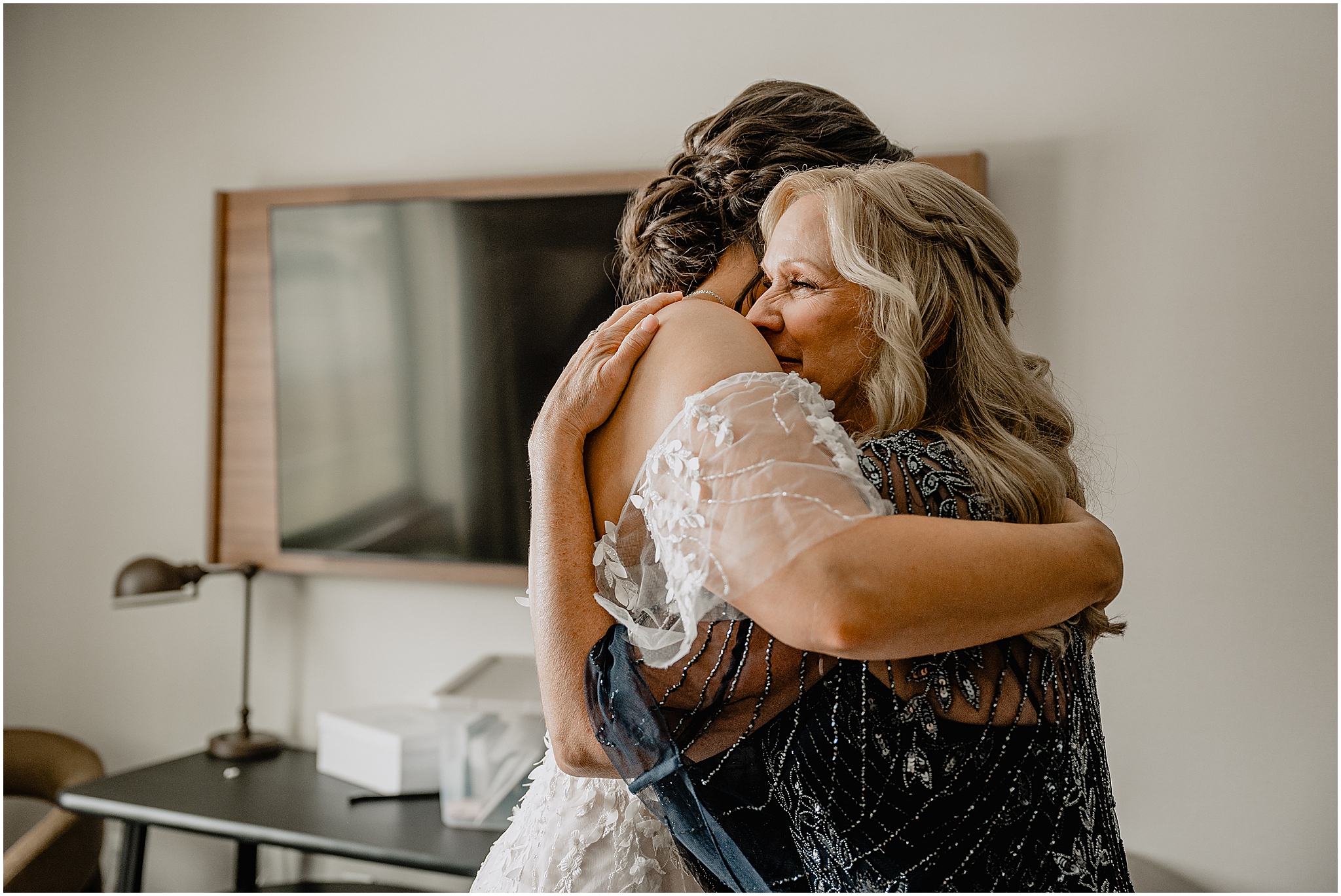 bride and mother hug in hotel room on morning of her wedding in New Jersey