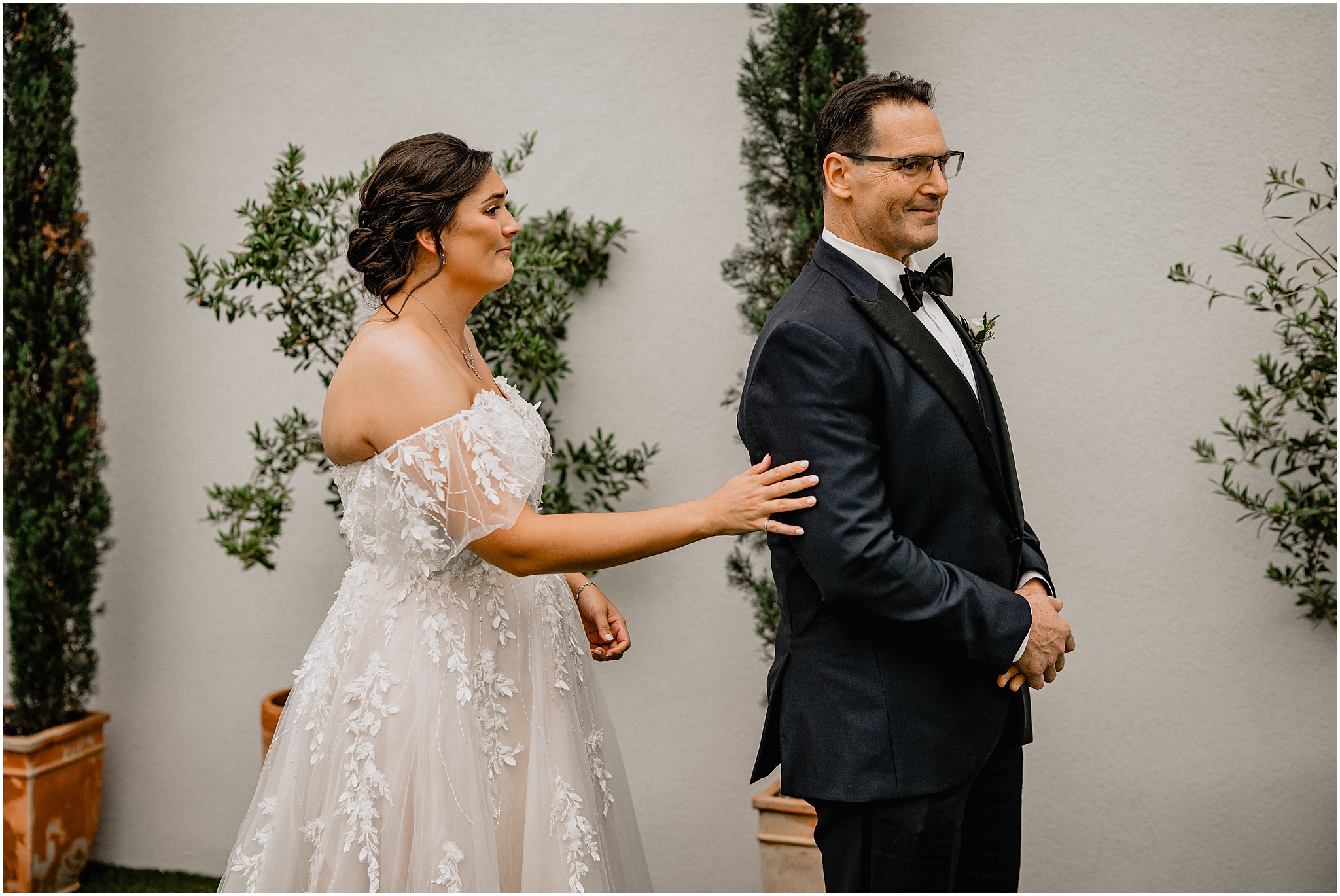 bride reaches to tap dad's arm during first look outside the Perona Farms Reserve