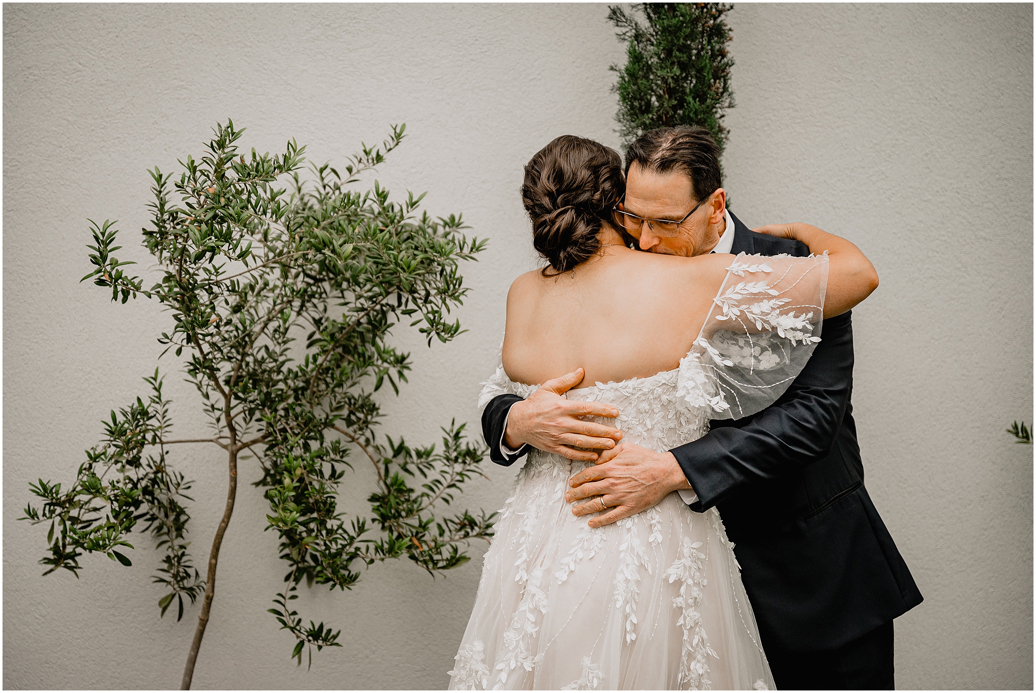 dad hugs bride during first look outside the Perona Farms Reserve