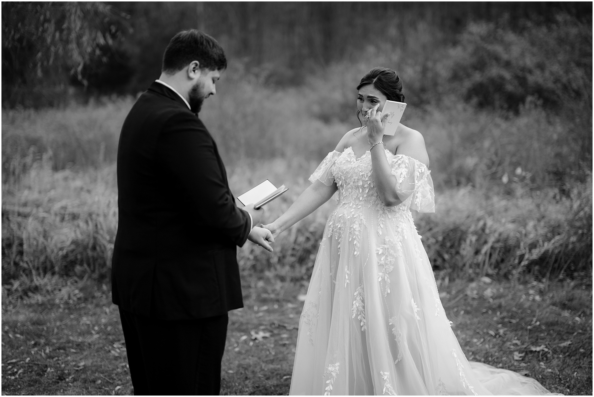 bride cries during first look with groom while he reads vows in field at the Perona Farms Reserve