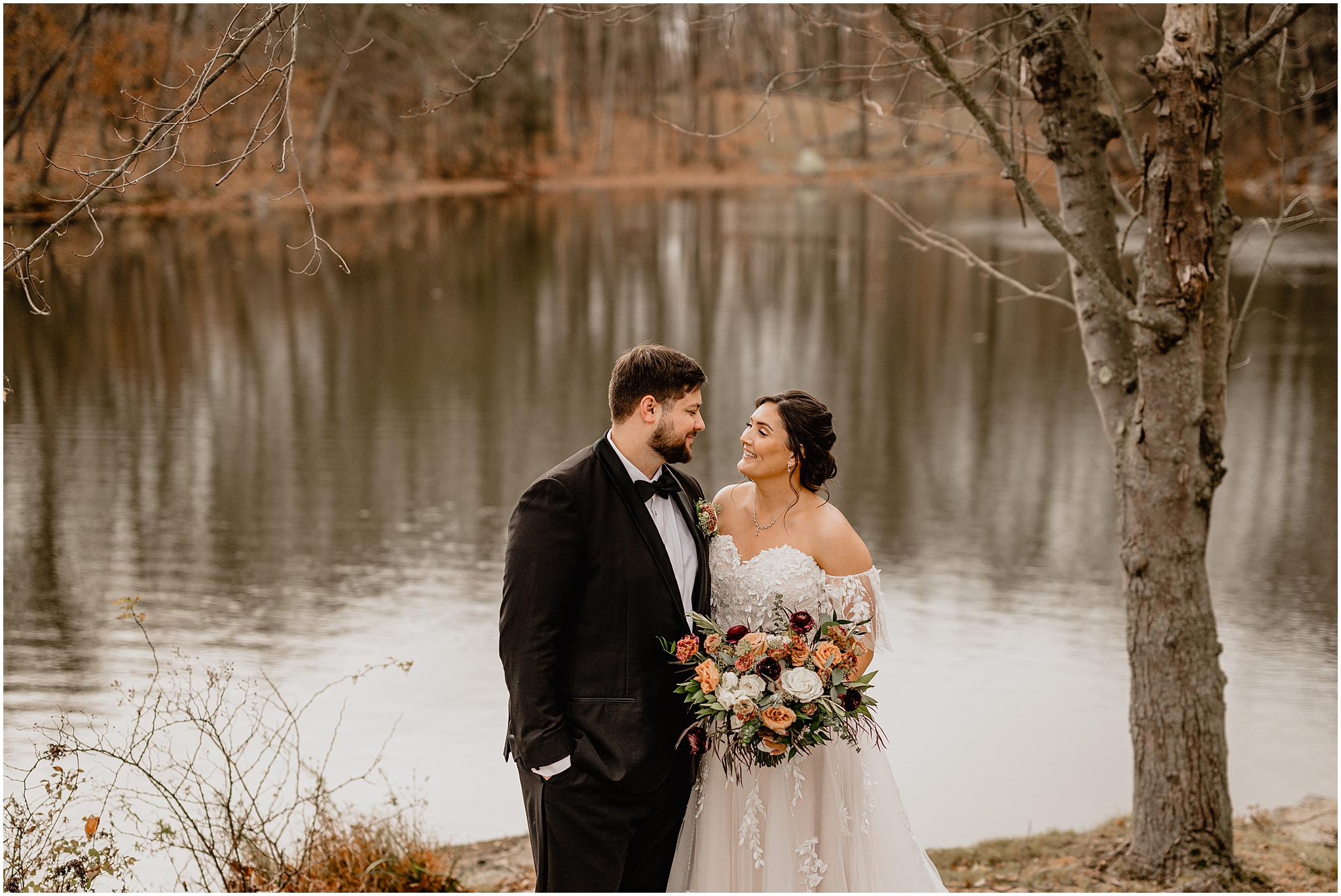 bride and groom hug in front of pond at the Perona Farms Reserve